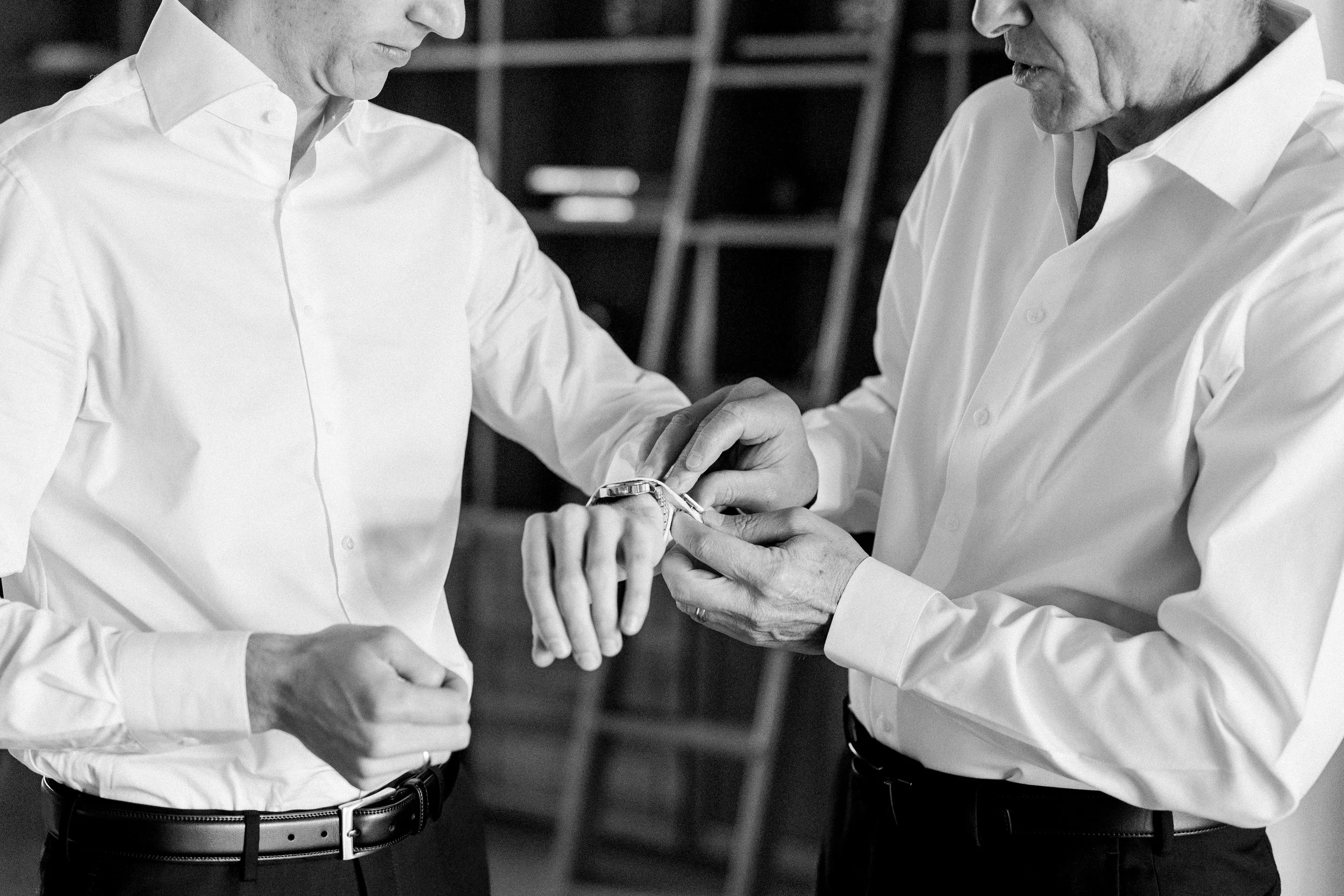 Groom getting ready at Tivoli Italian Villa in Escondido with soft window light