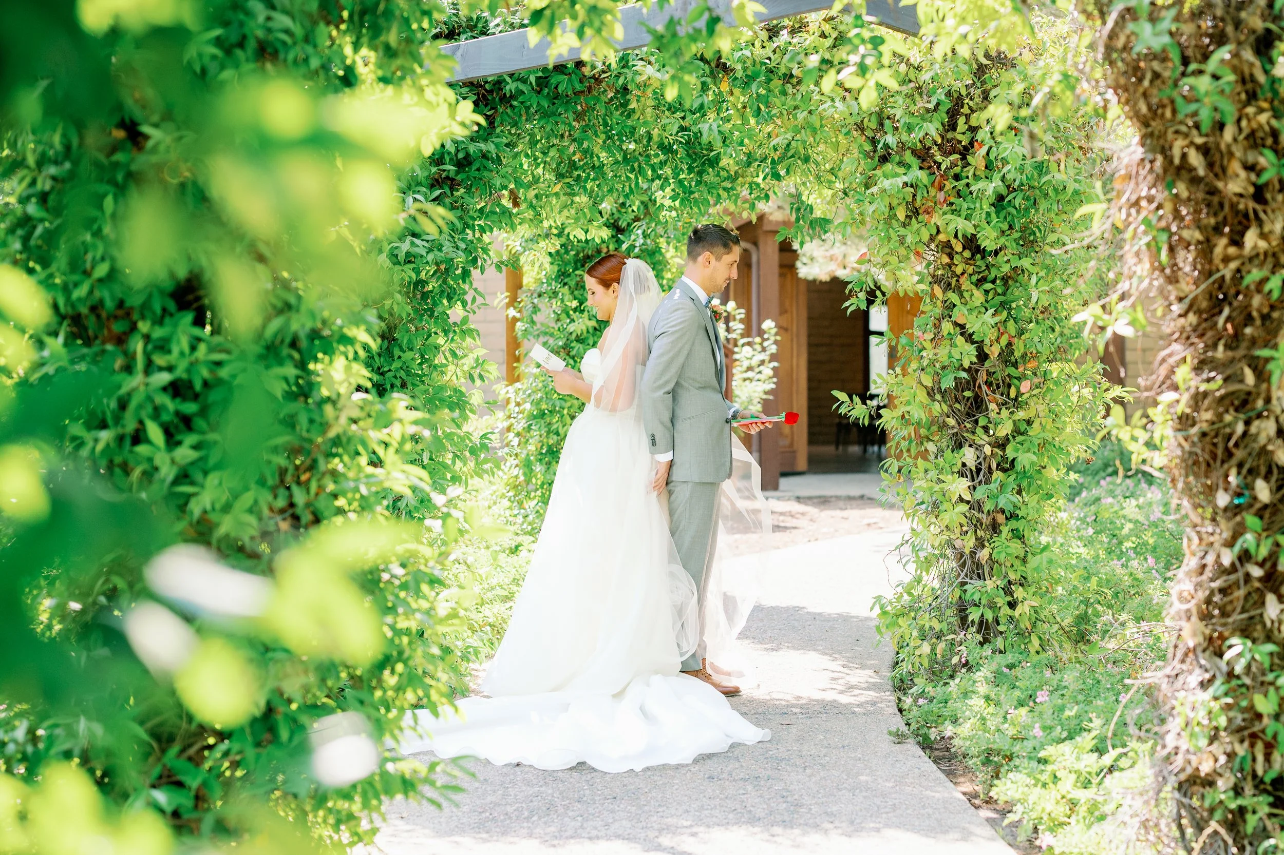 Couple sharing a first touch and personal vows at Ethereal Gardens wedding venue in Escondido