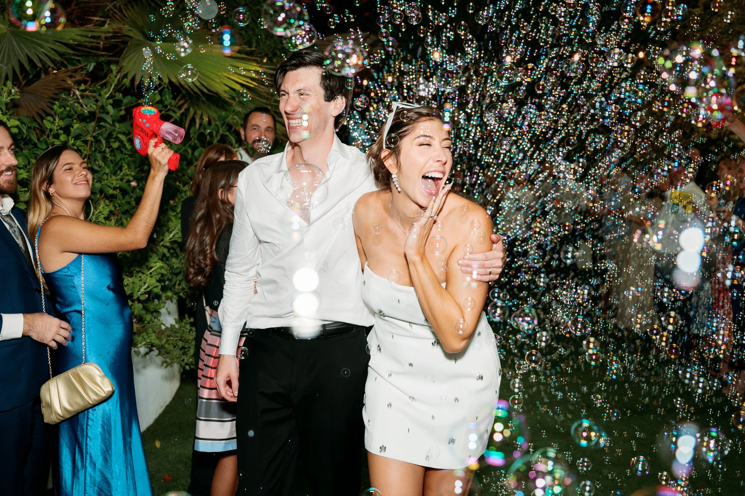 Bride and groom exiting through bubbles during grand exit at Tivoli Italian Villa wedding in Escondido, California