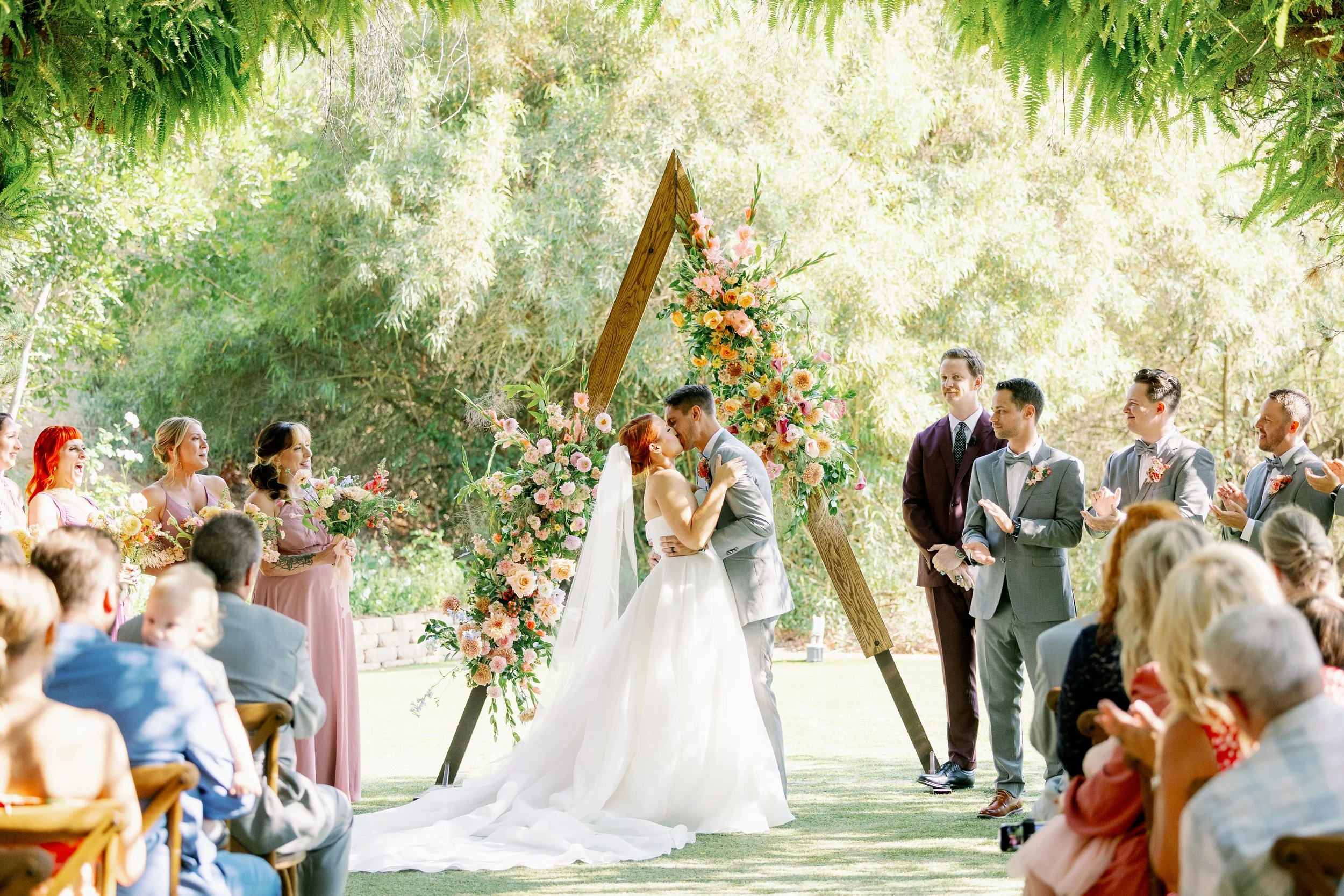 First kiss at an outdoor garden wedding in Escondido California