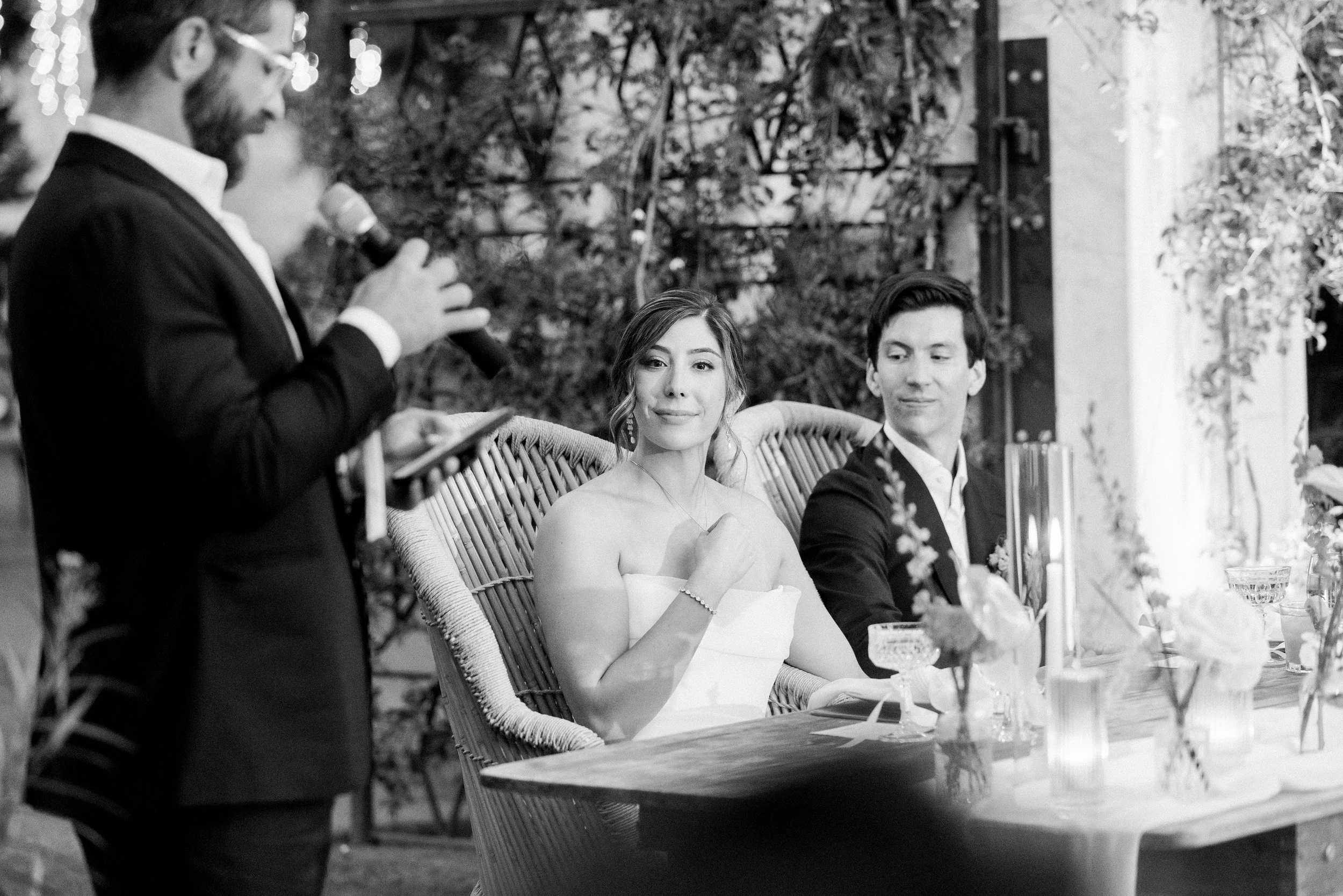 Bride and groom reacting during speeches and toasts at Tivoli Italian Villa wedding reception in Escondido, California