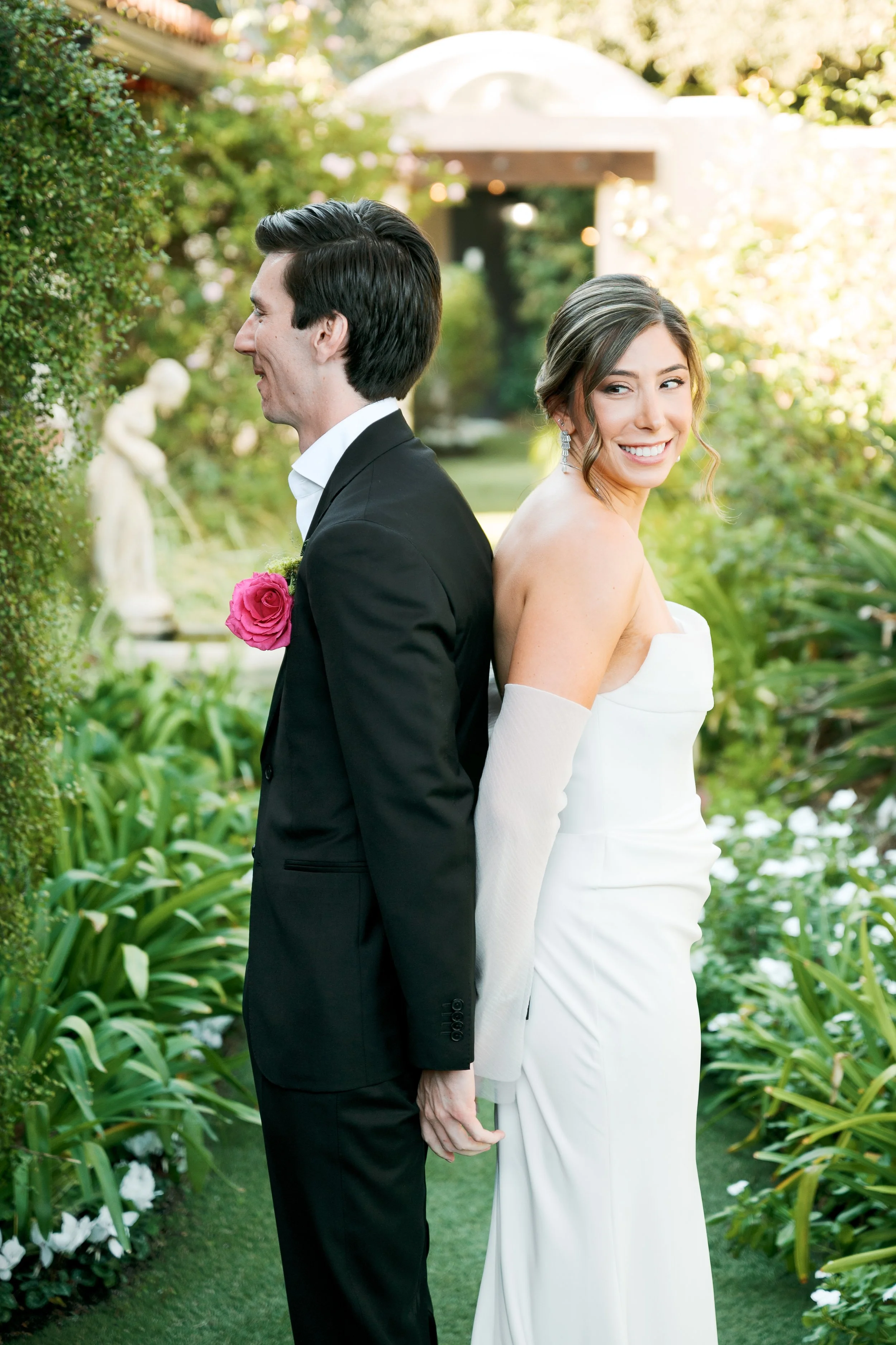 Bride and groom sharing a first touch before the ceremony at Tivoli Italian Villa in Escondido, California