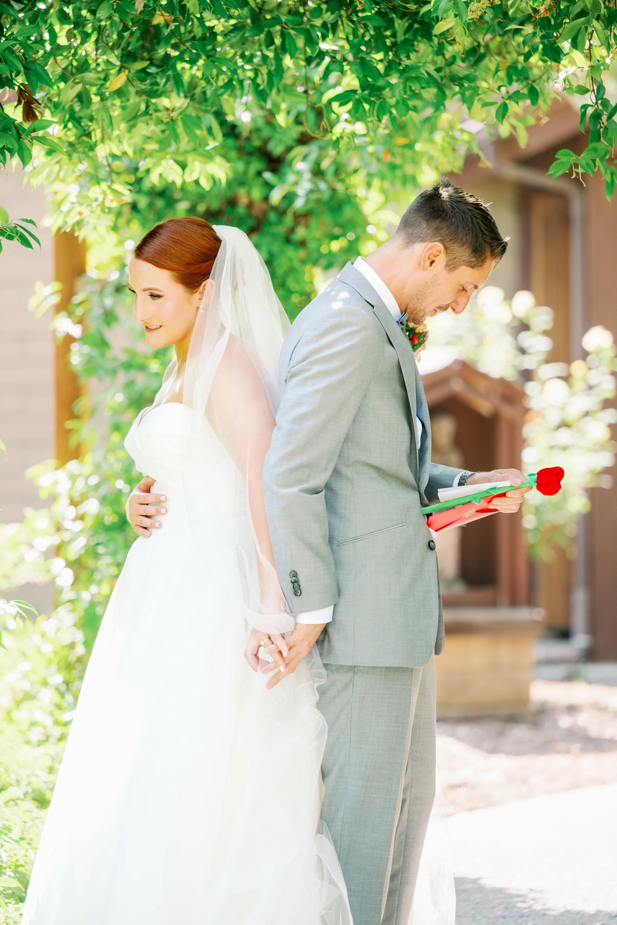 Couple sharing a first touch at Ethereal Gardens wedding venue in Escondido