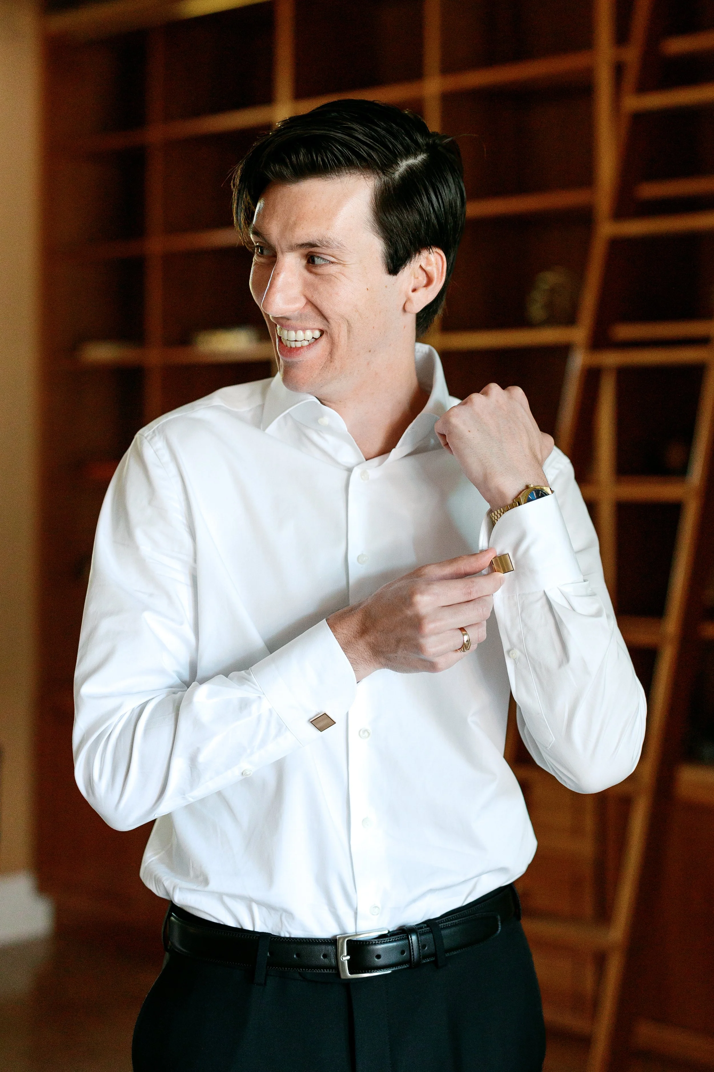Groom getting ready at Tivoli Italian Villa in Escondido with soft window light