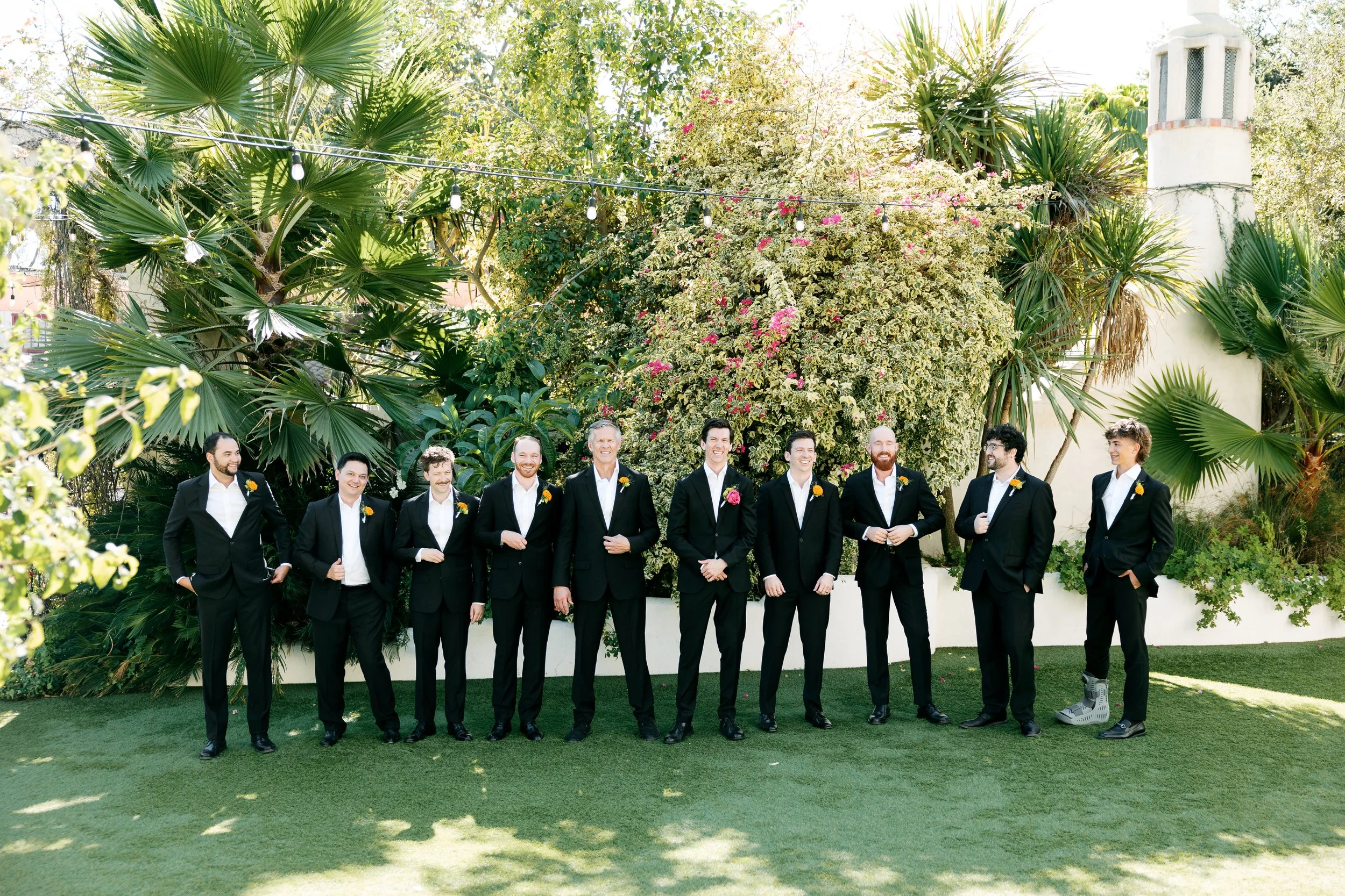 Groom and groomsmen posing together at Tivoli Italian Villa wedding