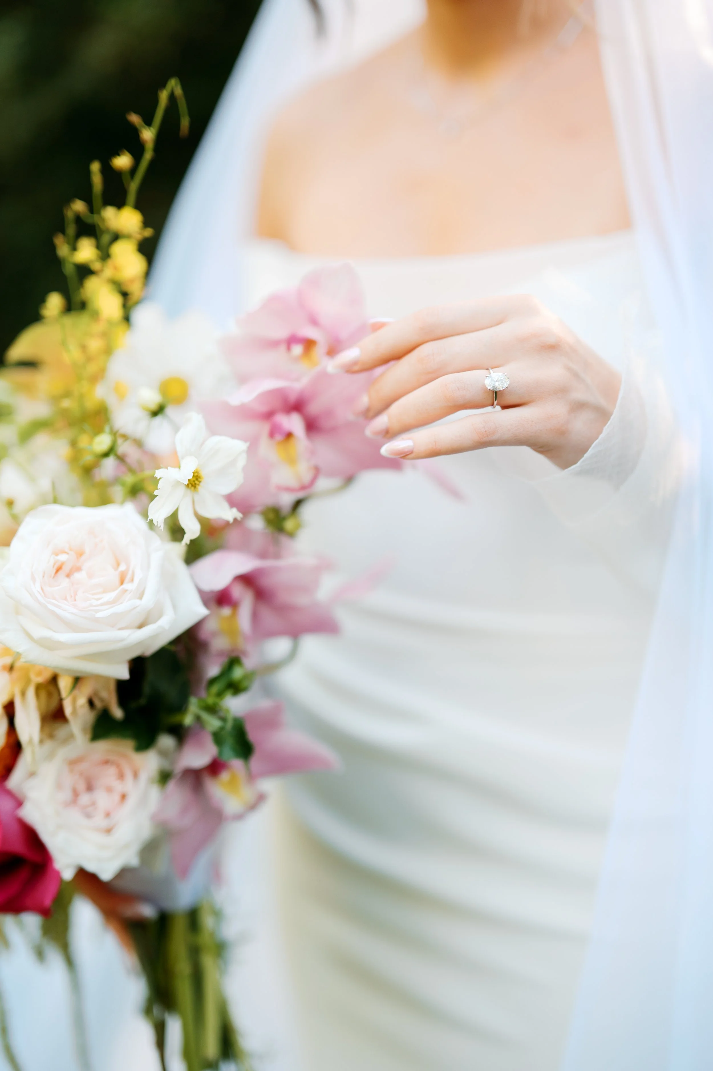 Close-up of bride touching her bouquet with engagement ring visible at Tivoli Italian Villa in Escondido, California
