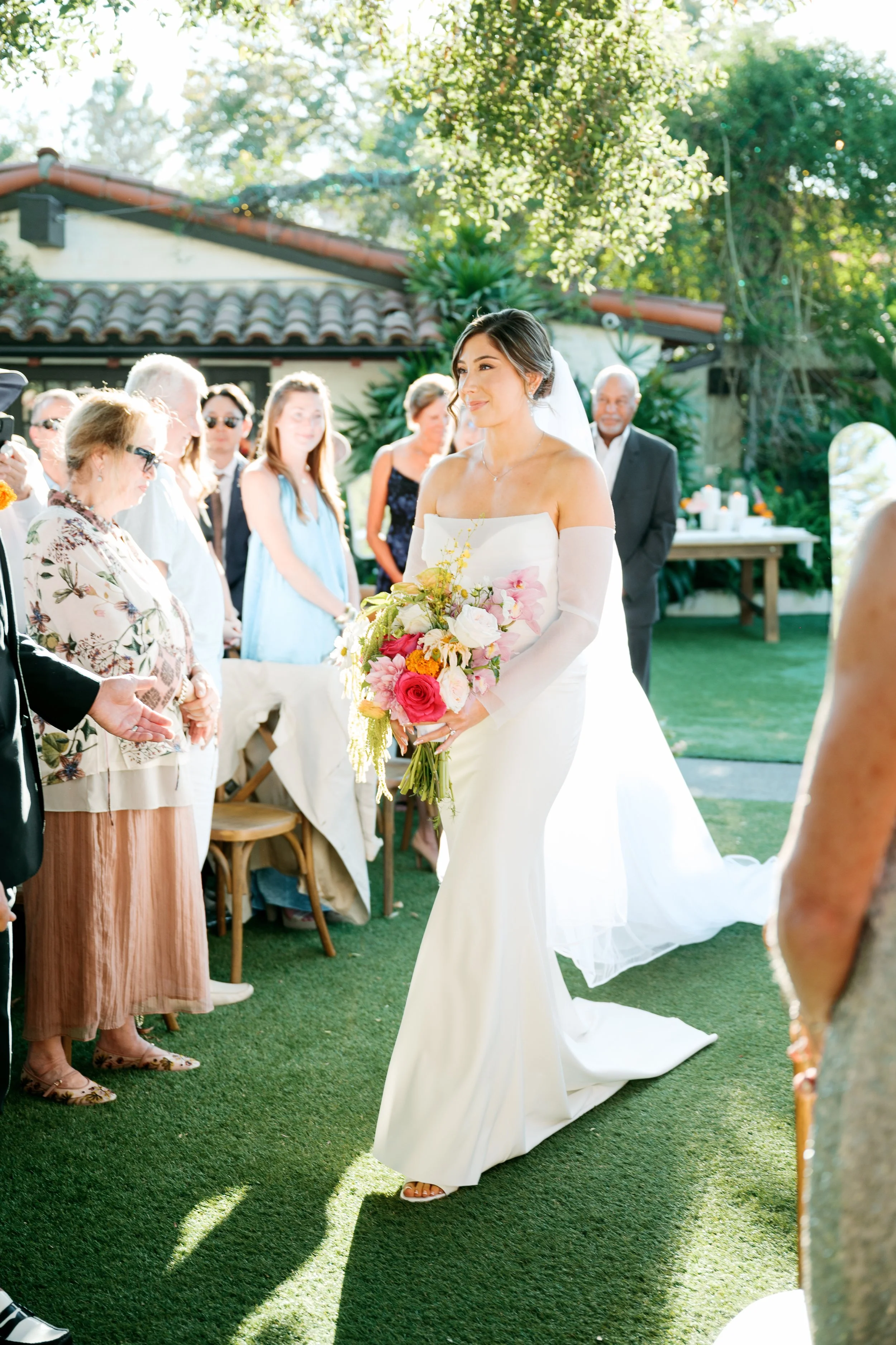 Bride walking down the aisle during the wedding ceremony at Tivoli Italian Villa in Escondido, California