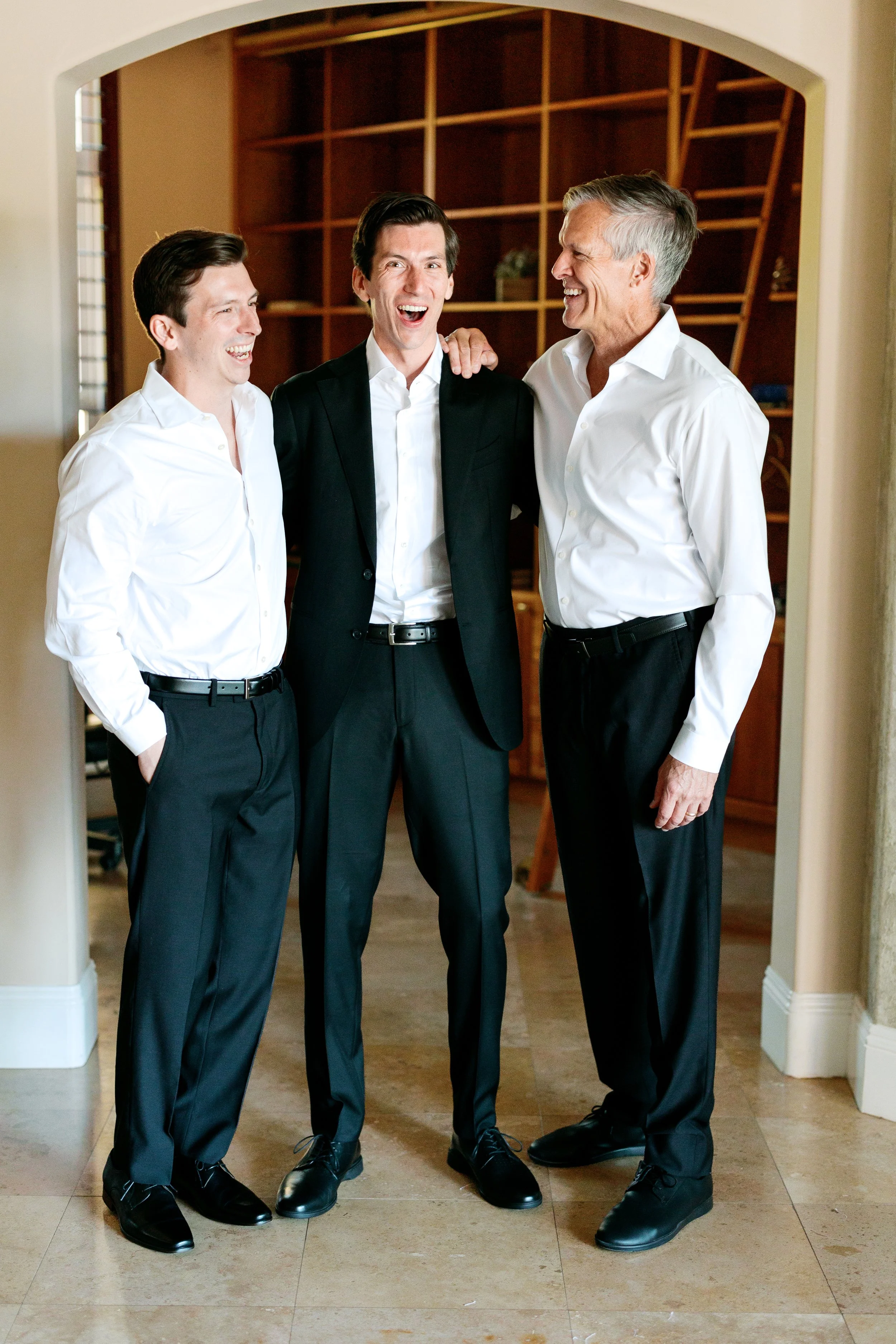 Groom getting ready at Tivoli Italian Villa in Escondido with soft window light