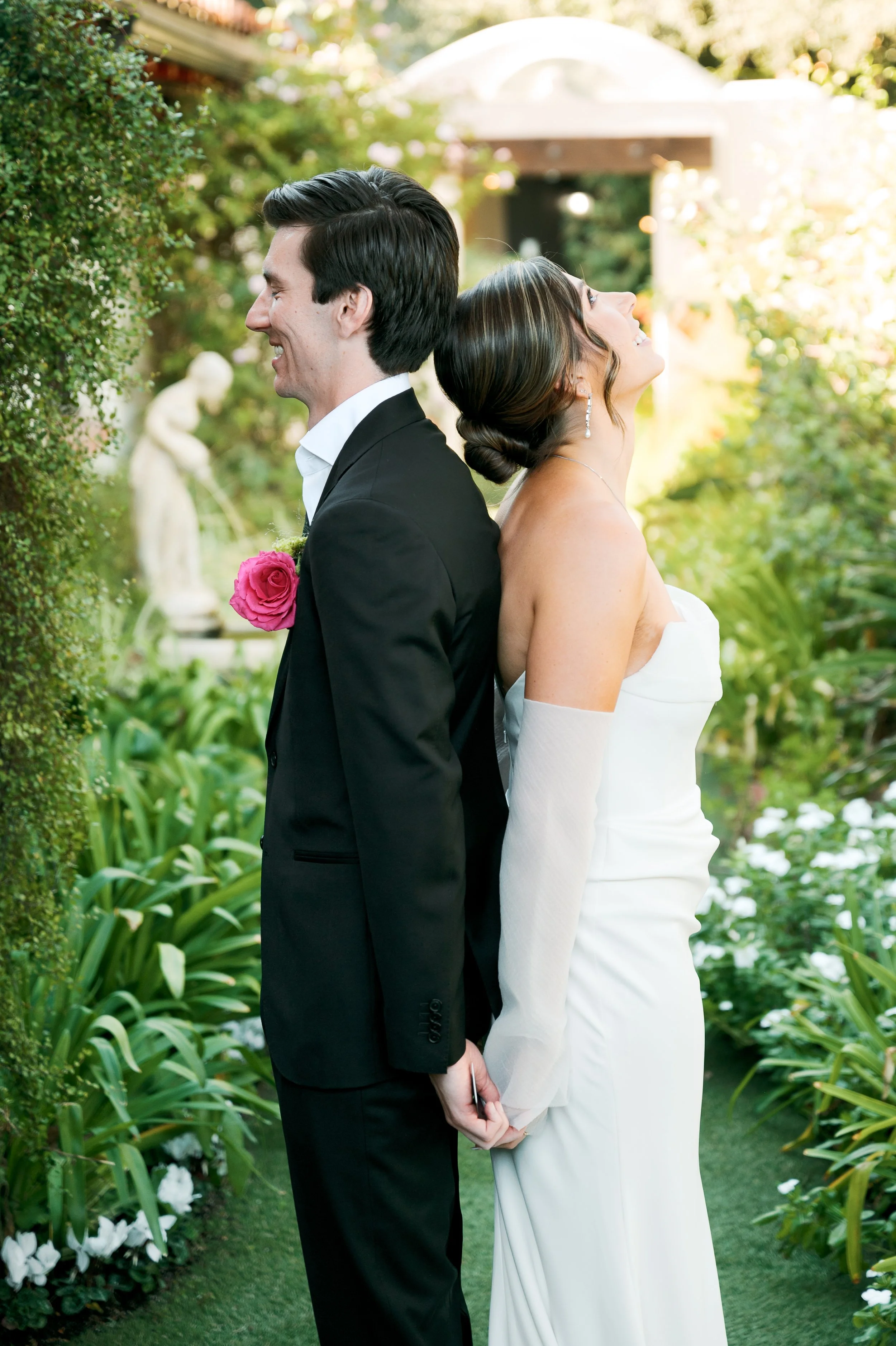 Bride and groom sharing a first touch before the ceremony at Tivoli Italian Villa in Escondido, California