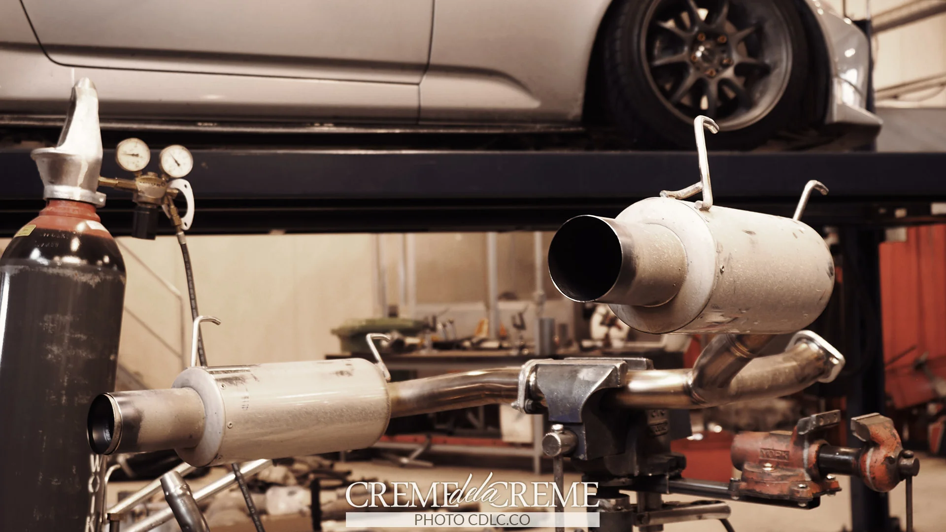 The Toda exhaust sitting on a work bench, having the tips fitted.