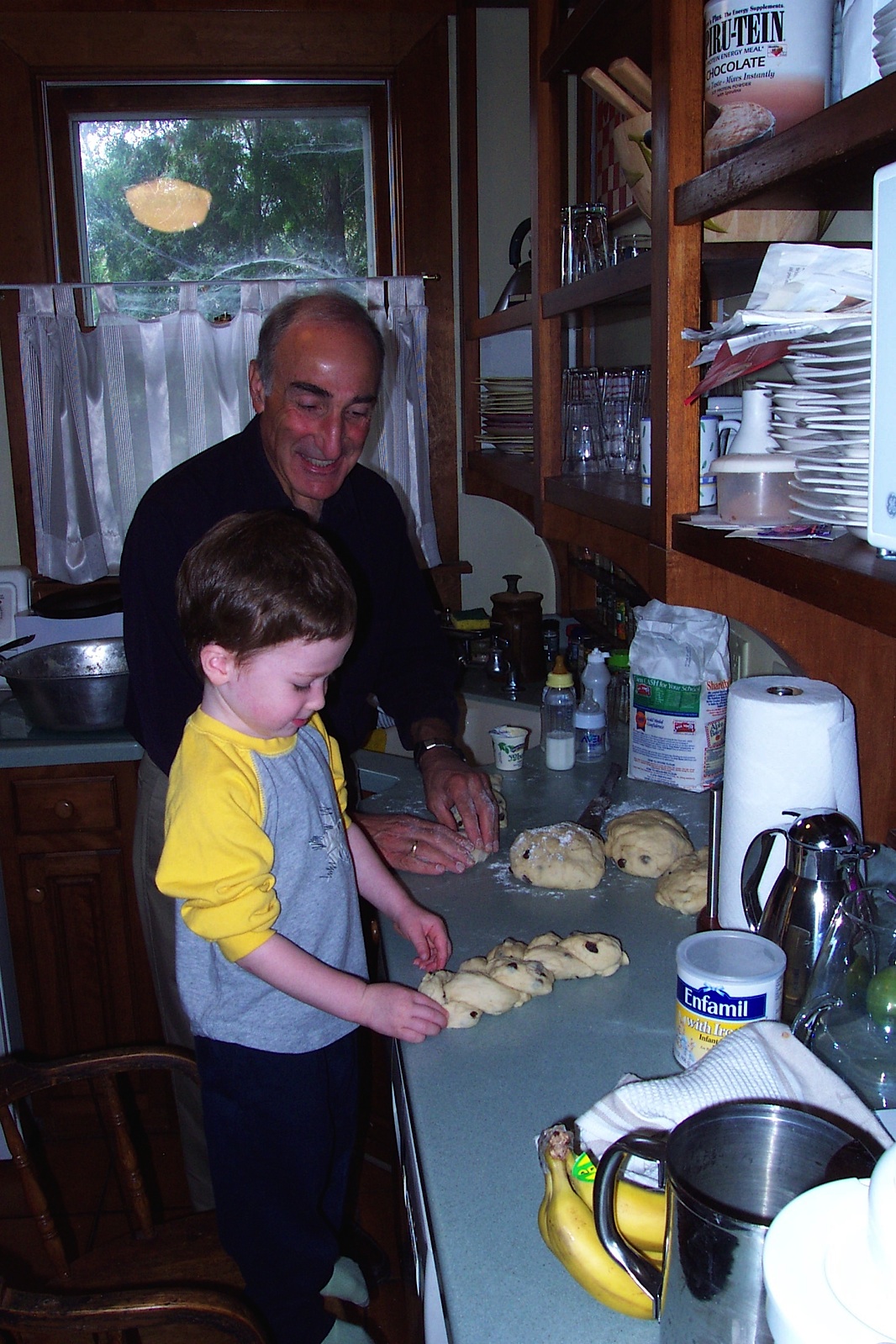 Harvey baking challah (12 years ago!) with grandson Abe, named after Hilda's late husband.