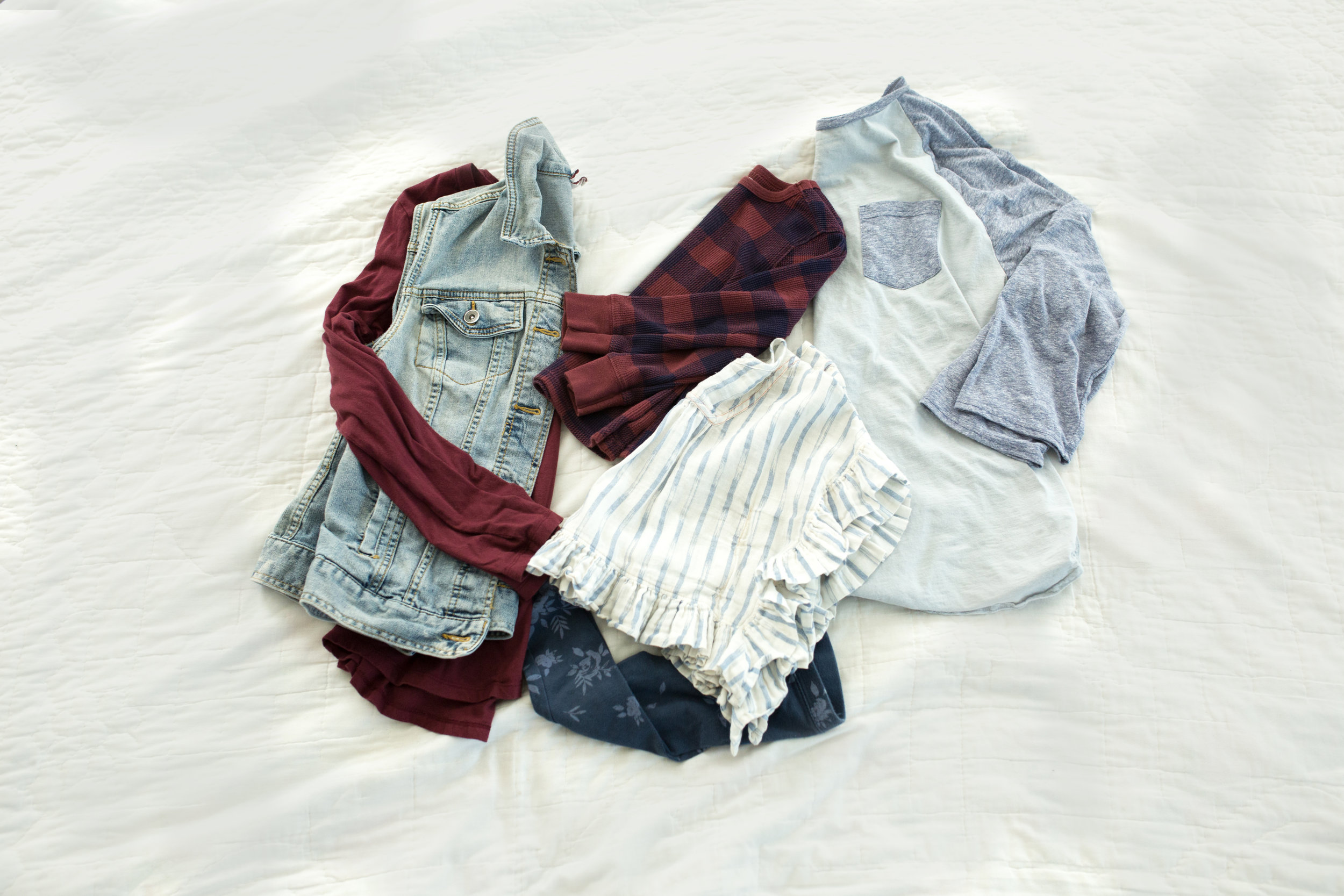 Girl in fun striped flowy top and floral leggings. Boy in navy and maroon gingham print thermal with jeans. Dad in baseball tee with jeans. Mom in maroon top and denim vest. Pair with a skirt or skinny dark jeans with ankle boots.