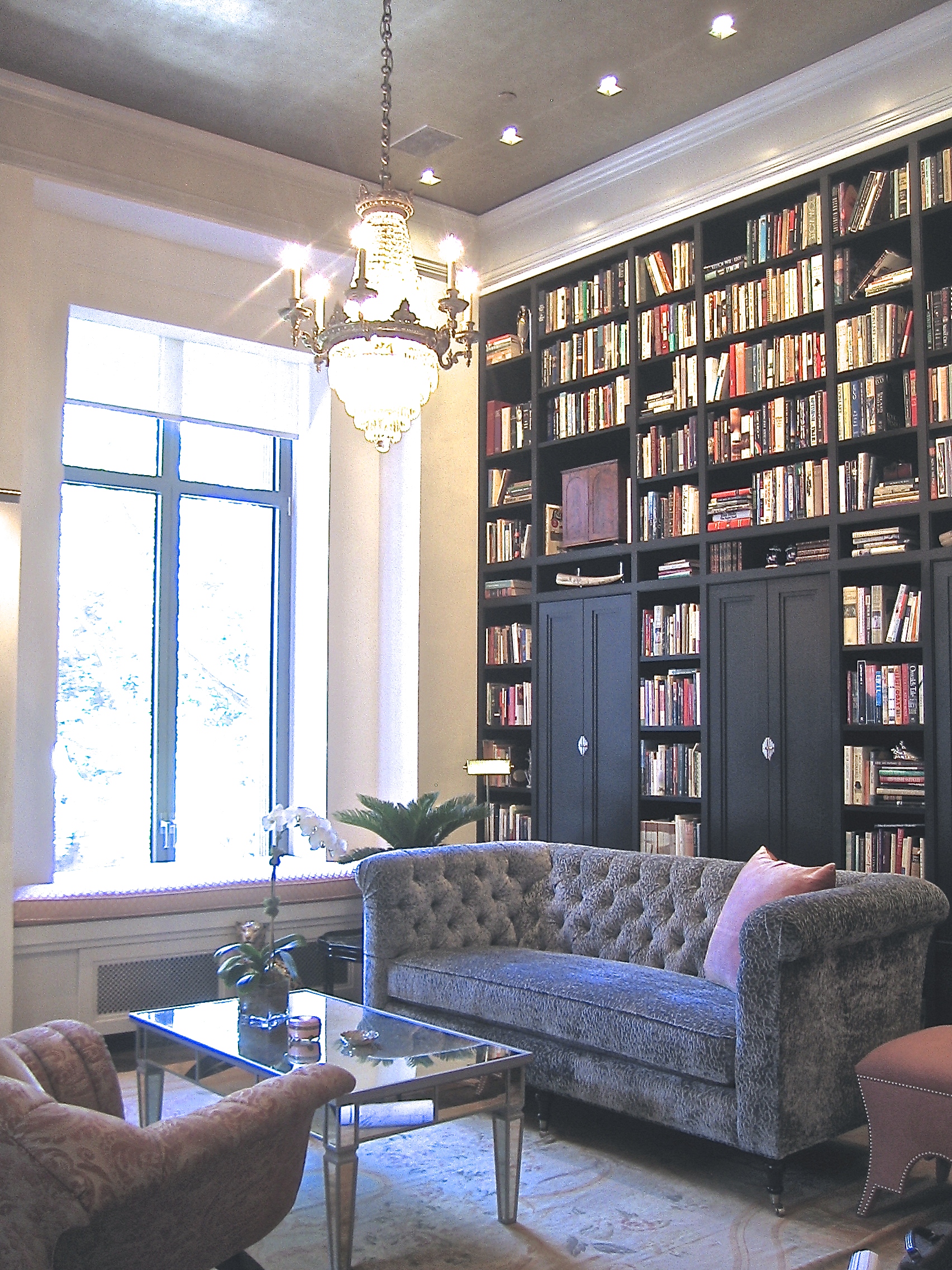  This 2000 sq. ft. apartment was designed to maximize the impact of the 14' high ceilings and a large collection of books. The large Great Room includes a double height library, a dining area, a sitting area, and an office area with views out to Madi