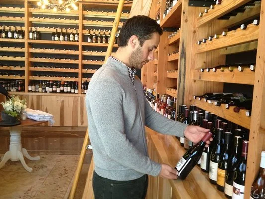 Brian exams the well-stocked shelves at Les Marchands
