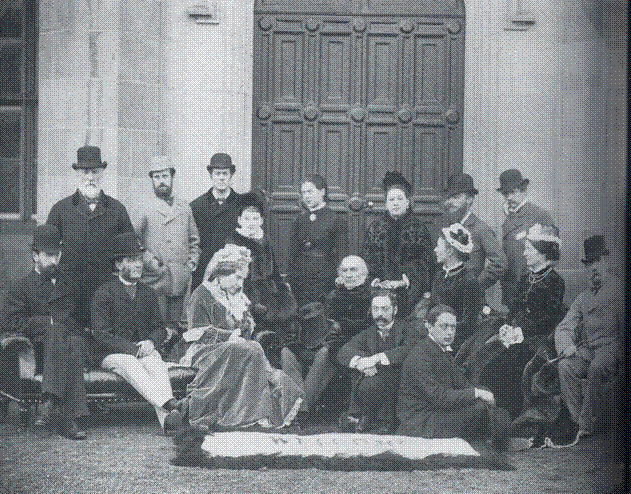 Photograph taken at Dalmeny House of a house party in 1879. Included in the photograph are W.E. Gladstone (holding his hat)and his wife Catherine (seated, front) and daughter Mary Gladstone (standing, center), the Earl and Countess of Rosebery (seated front right, and standing third from right), and the Countess's cousin Ferdinand James von Rothschild. This photograph is over 125 years old, thus in public domain by virtue of age.