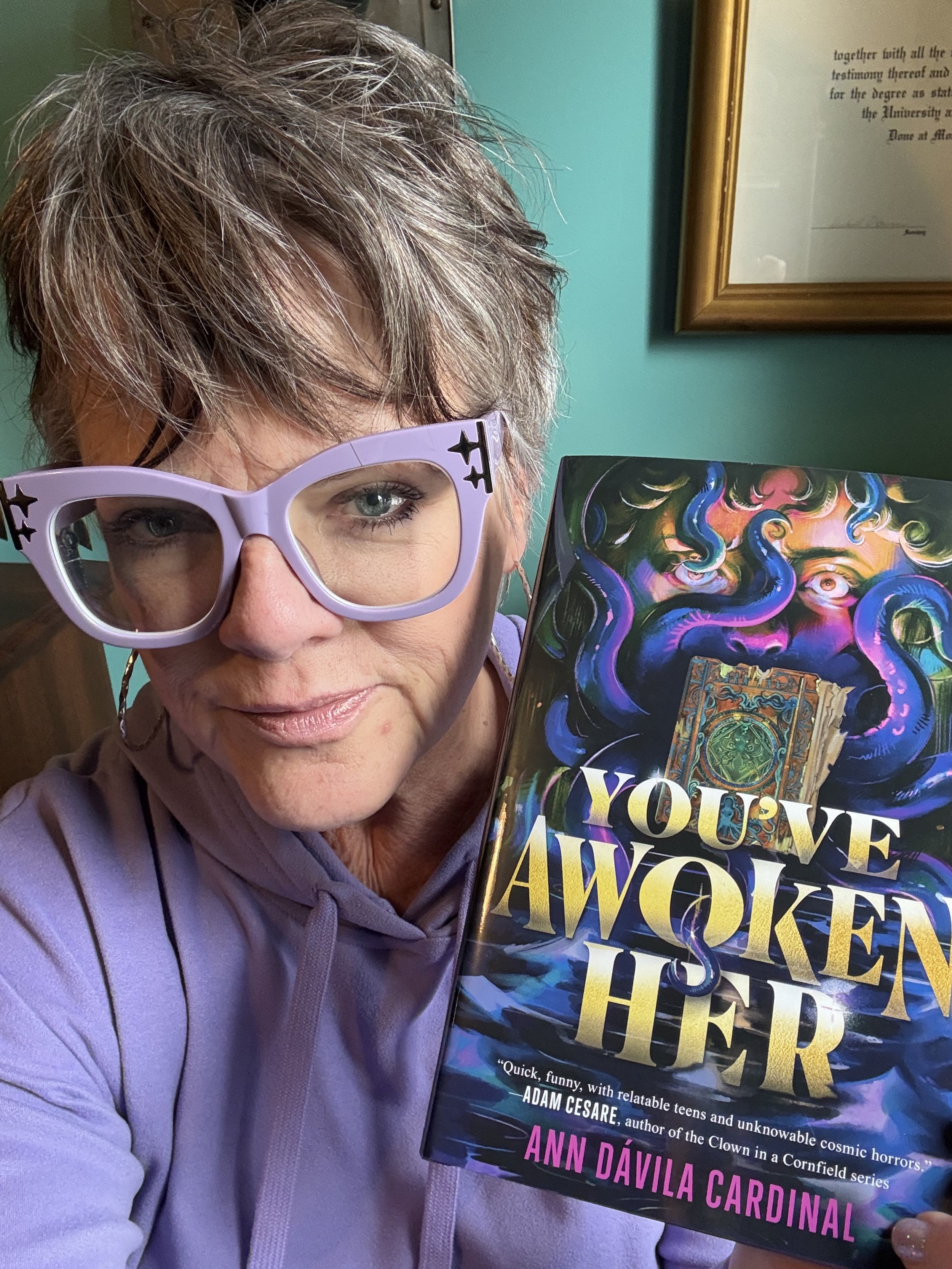 Ann with fresh off the presses copy of You've Awoken Her!