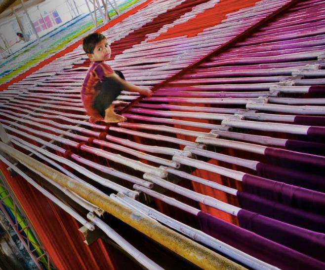 Child working in textile industry. Photo courtesy of The Guardian .