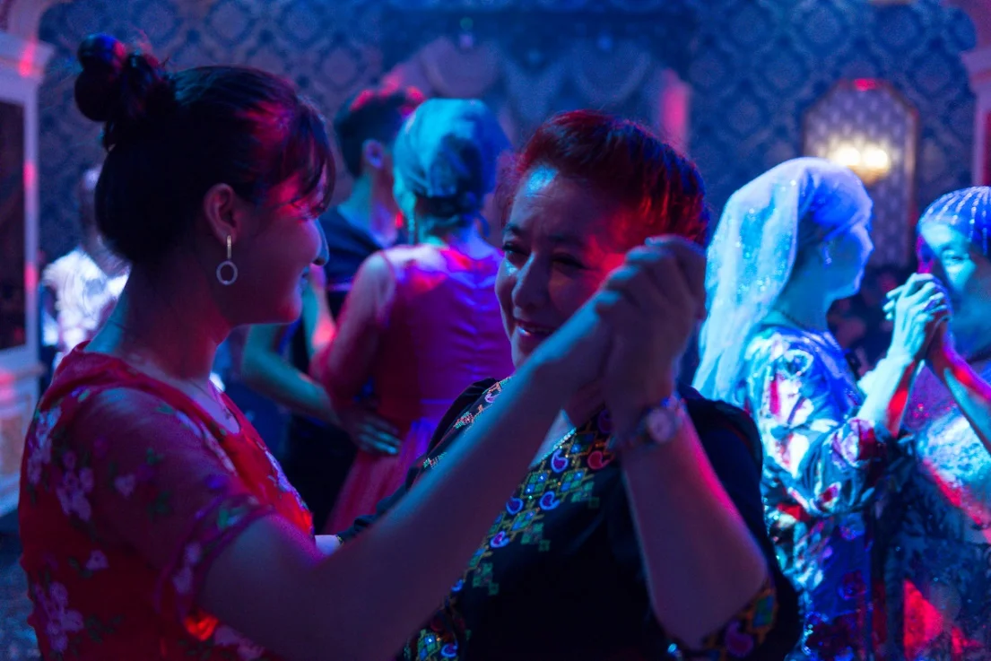 A mother and daughter dance together at Memetjan’s wedding celebration. Generally, men and women do not dance a waltz style dance unless they are related to each other, but now there is also simply an absence of men at many of these events.