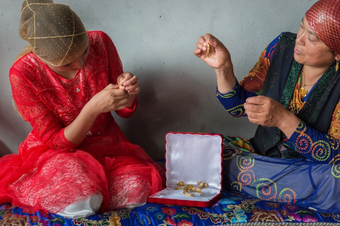 After days of celebrations, a Memetjan’s bride is presented with gold jewelry in her husband's home.
