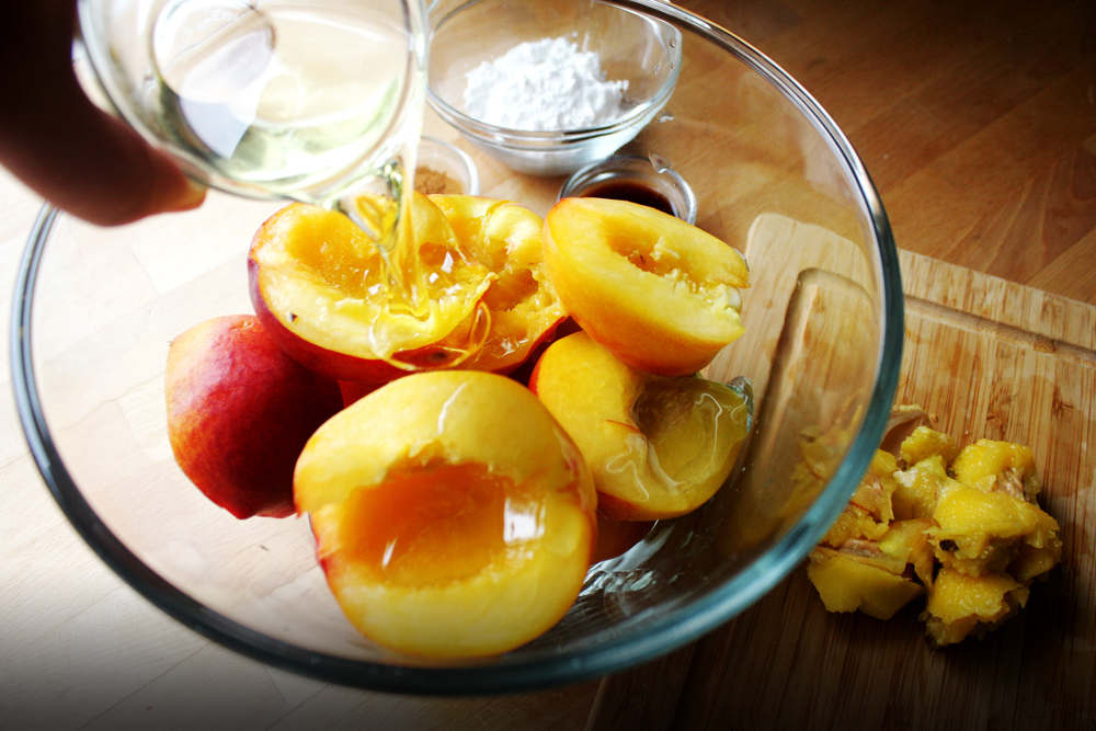   Coat the halved and pitted peaches in vegetable oil.  