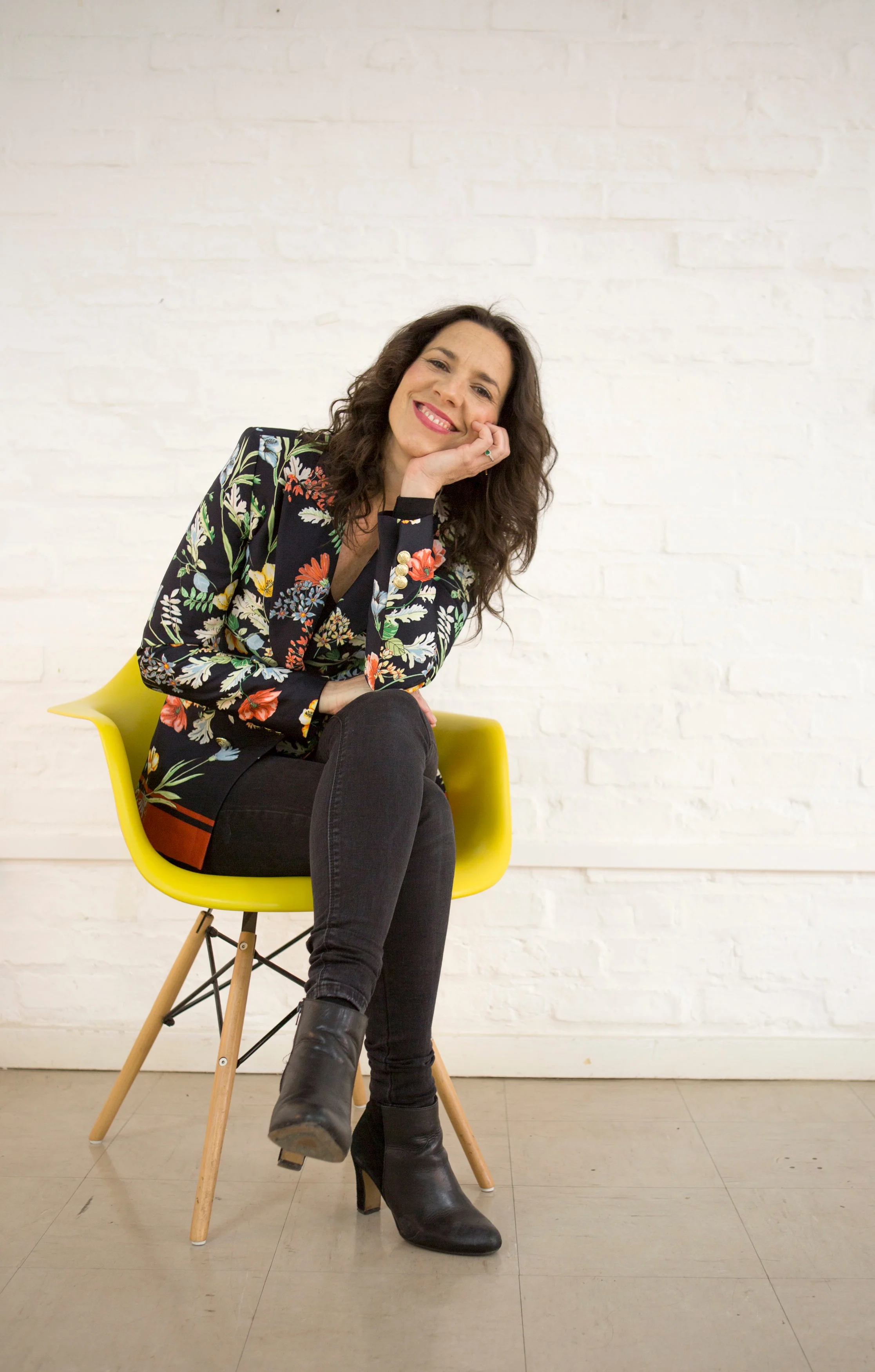 Selina sitting on a chair smiling.jpg