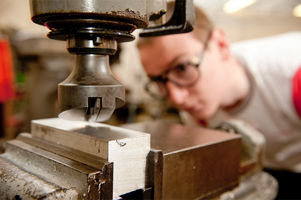 A Motorsport student works on machinery in the engineering workshop at the University of Derby's Markeaton Street site.
