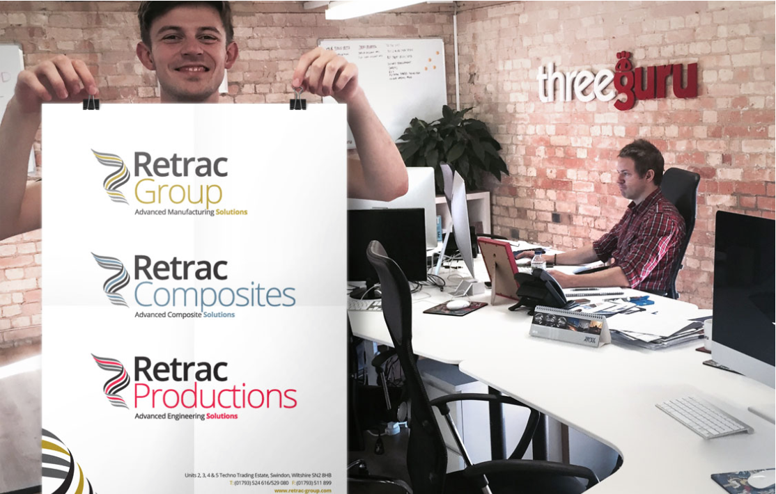 Chris Reynolds, Creative Director at three guru proudly showing off the refreshed logo artwork