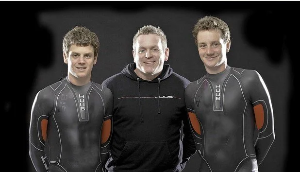 Found of HUUB, Dean Jackson, pictures with triathletes Jonathan and Alistair Brownlee.