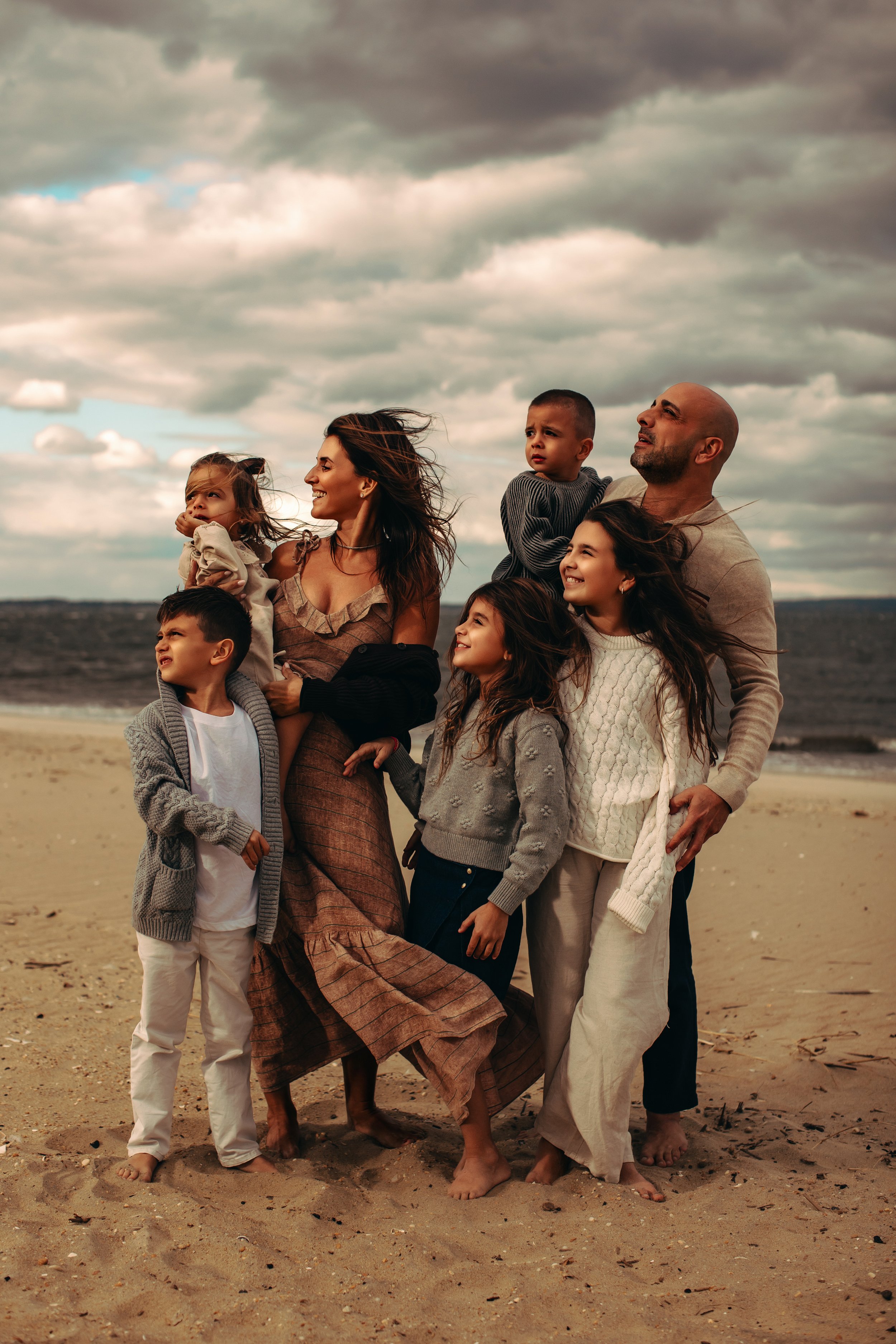 Family on a windy beach with cloudy sky