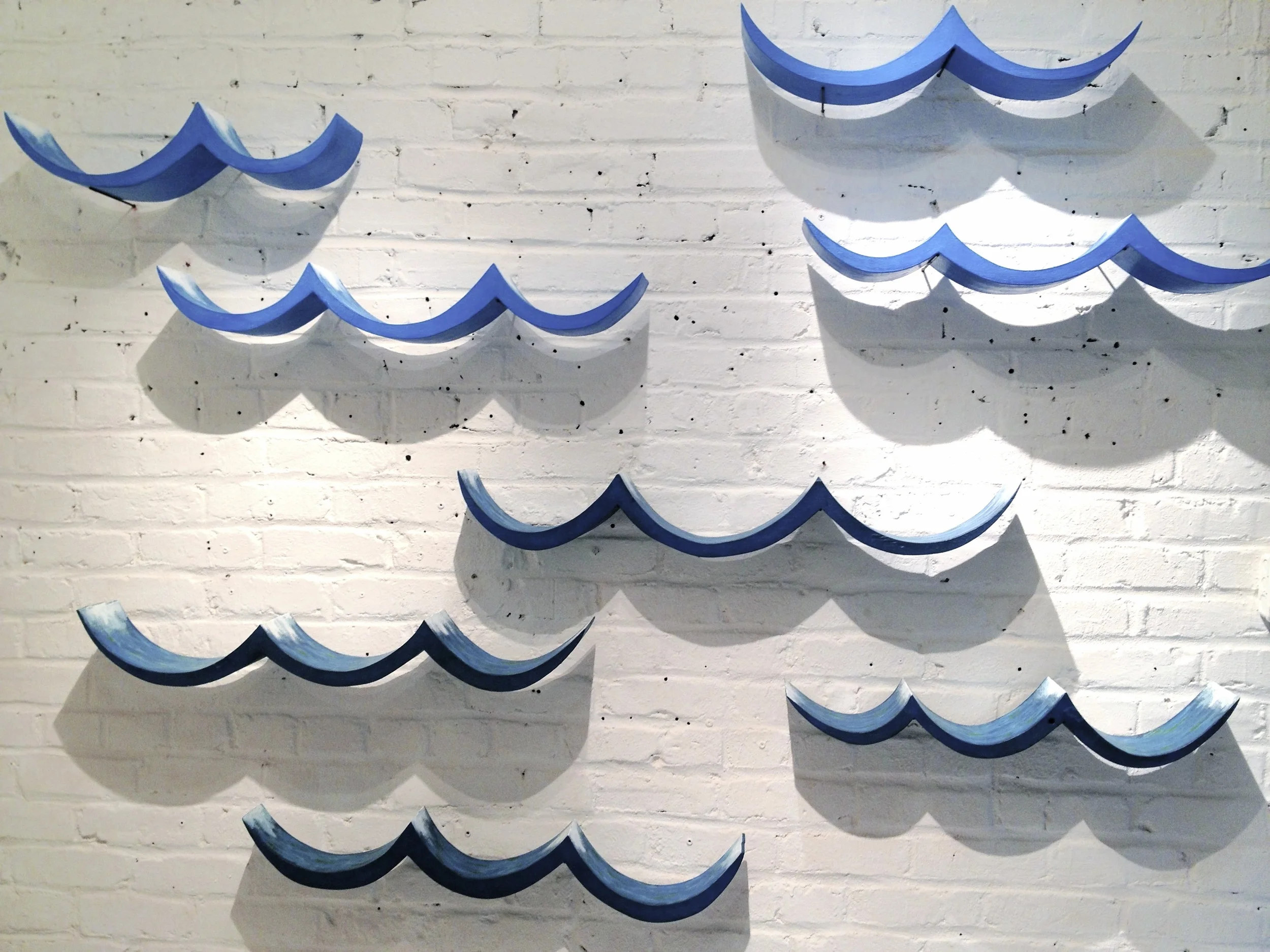  Waves (ocean), pine, milk paint, 2012-13, installation&nbsp;dimensions vary (each wave approx. 36" - 42" x 6") 