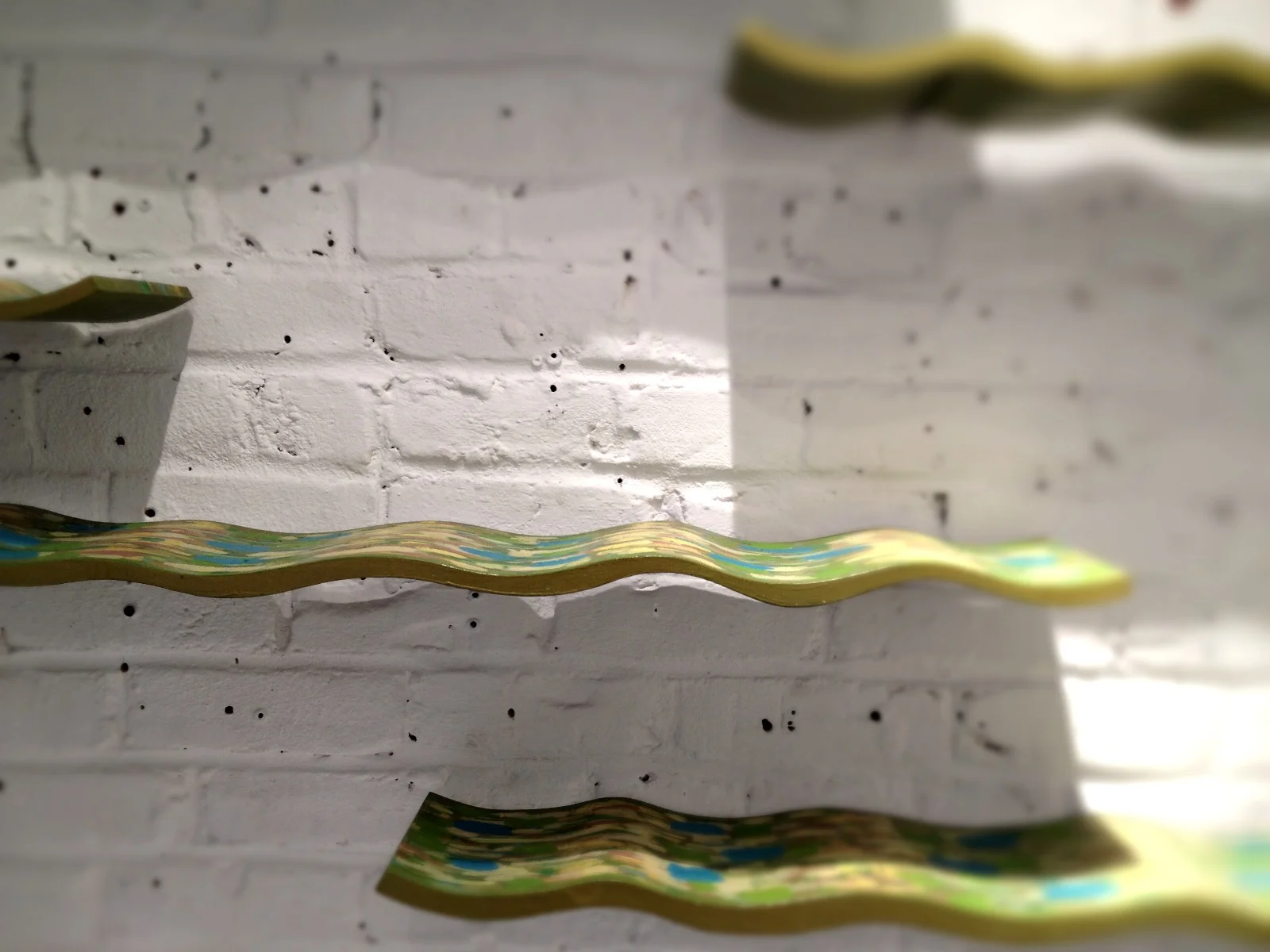  Waves (river), pine, milk paint, 2012-13, installation&nbsp;dimensions vary (each wave approx. 36" - 42" x 6") 