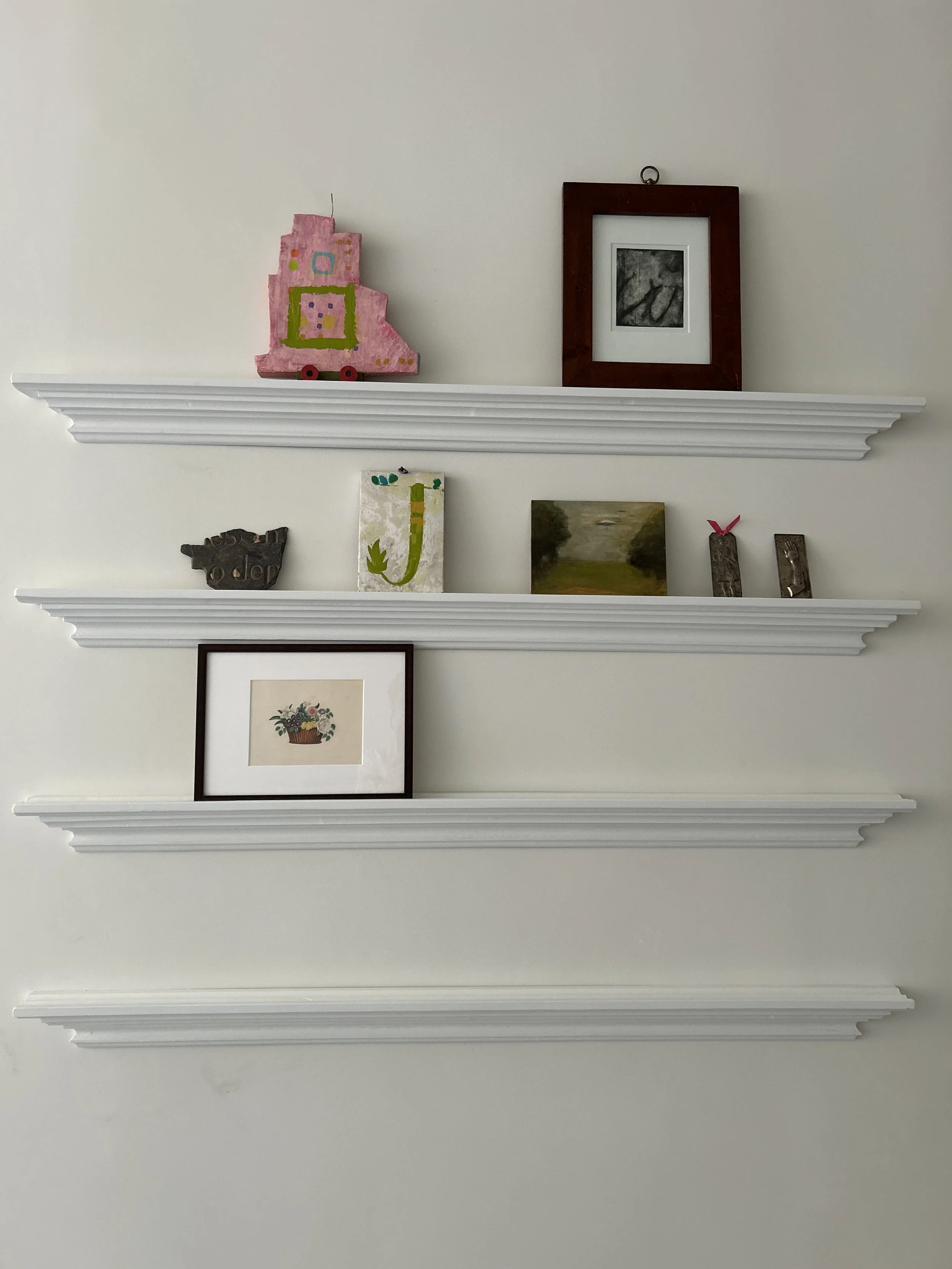  Small shallow shelves hold some of our precious objects. Let the interior decorating begin. 