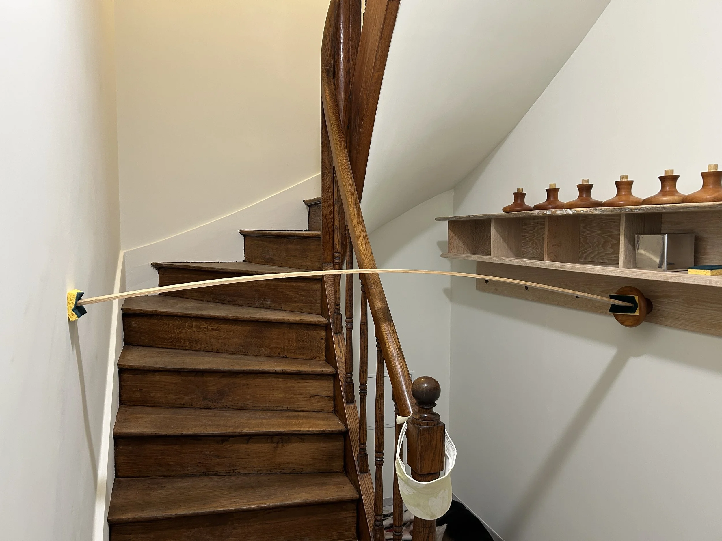  An elegant solution to apply pressure to the coat hooks while the glue dries. 