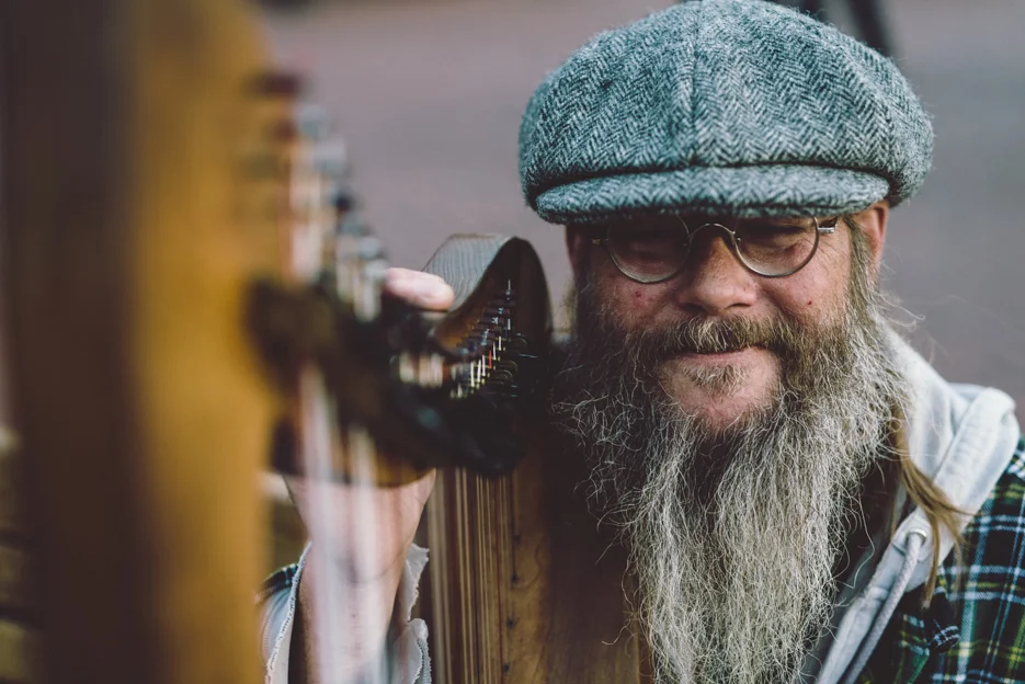 Gaffer took a moment with eyes closed and sat with his harp after he finished a song.