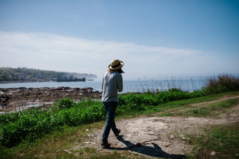 My mom, exploring the coastline by the house.