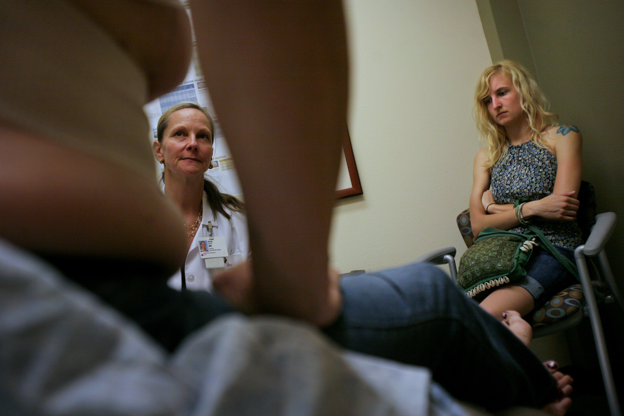  Elena's youngest daughter, Gina, 19, listens as Dr. Amy Wandel consults Elena on her recent breast enhancement surgery. In the first year of her transition, Elena had said she did not want breast surgery, and would be happy to continue wearing breas