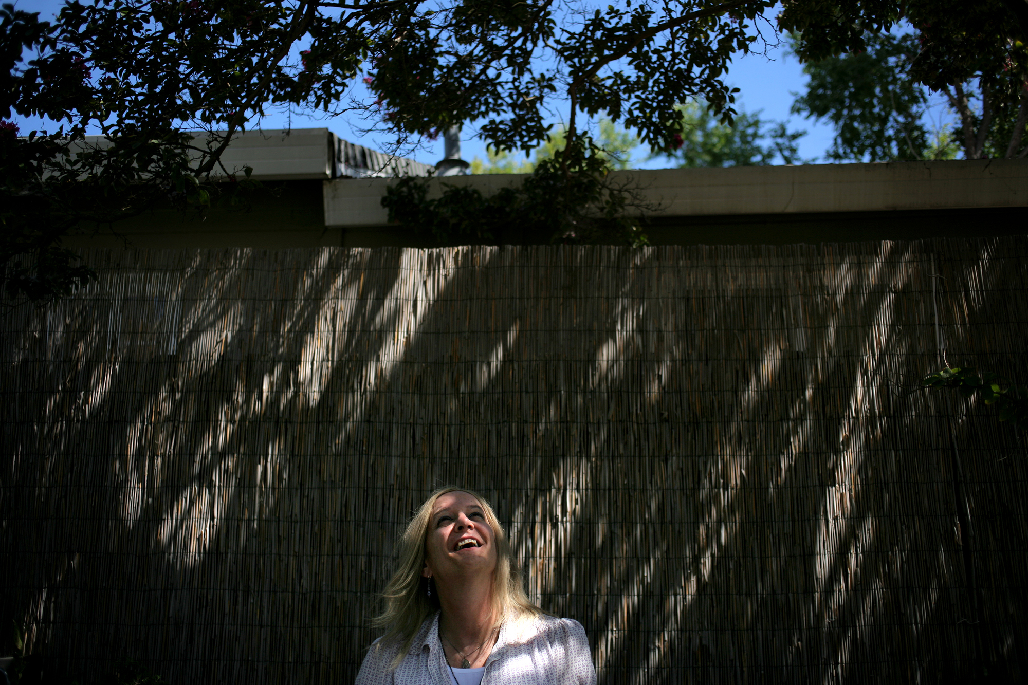  Elena laughs in the backyard of a close friend on a warm autumn day. "My hope was, in the next two or three years, to be where I am now," she said. "And it was in one. In less than one, actually." 