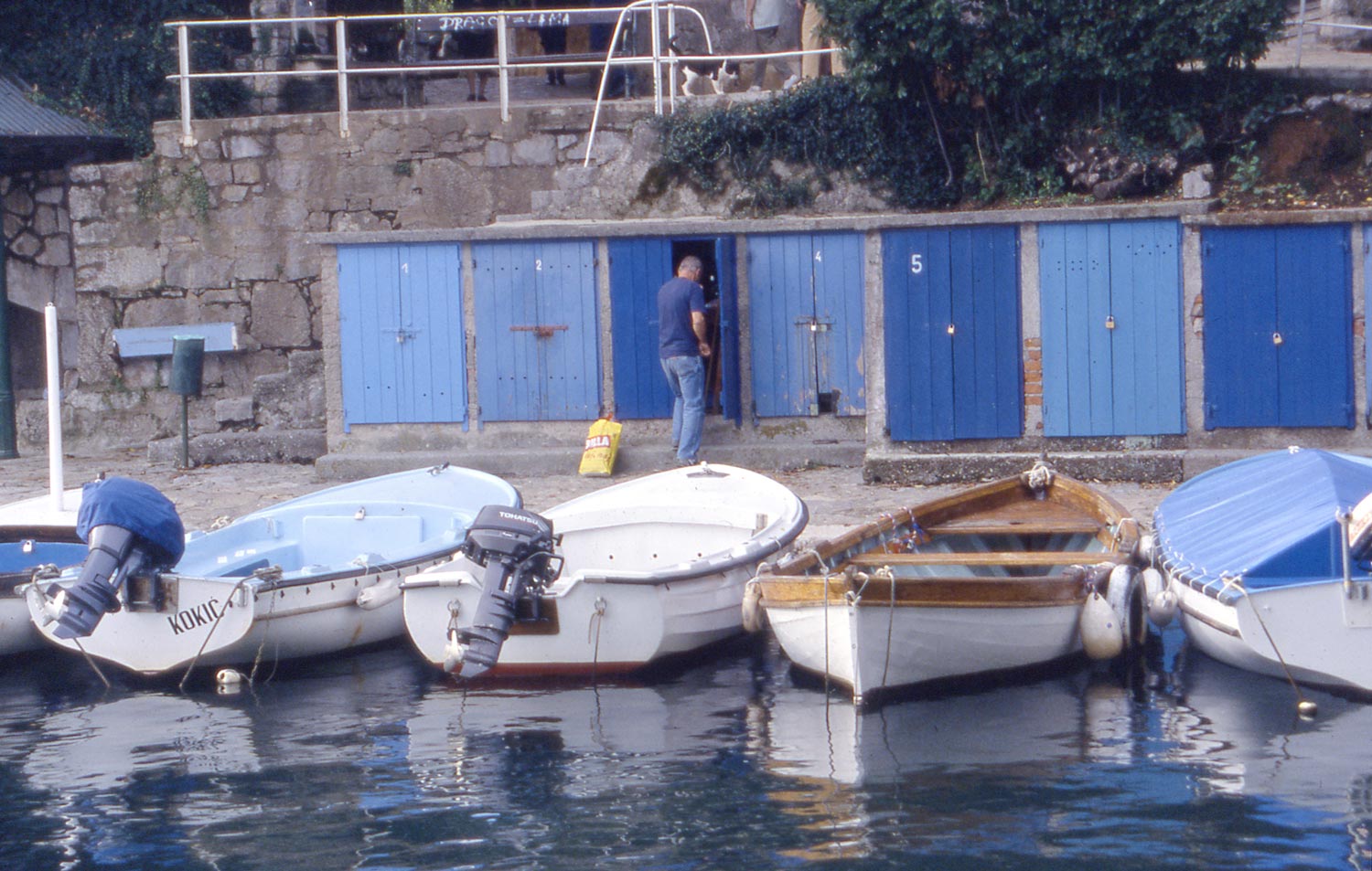 B. Opatija, Croatia If you squint and look at the reflections of the boats, you will see that the tonal range is not as great as the tonal range of the actual boats. Also you can see the mirror quality of the water allowing you to see the underside of the boat on the far right of the picture.
