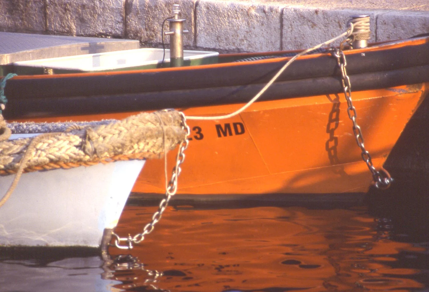 E. The Orange Boat It can be clearly seen in this close up photo of a vibrant orange boat that the reflection hasn’t the same intensity of colour.