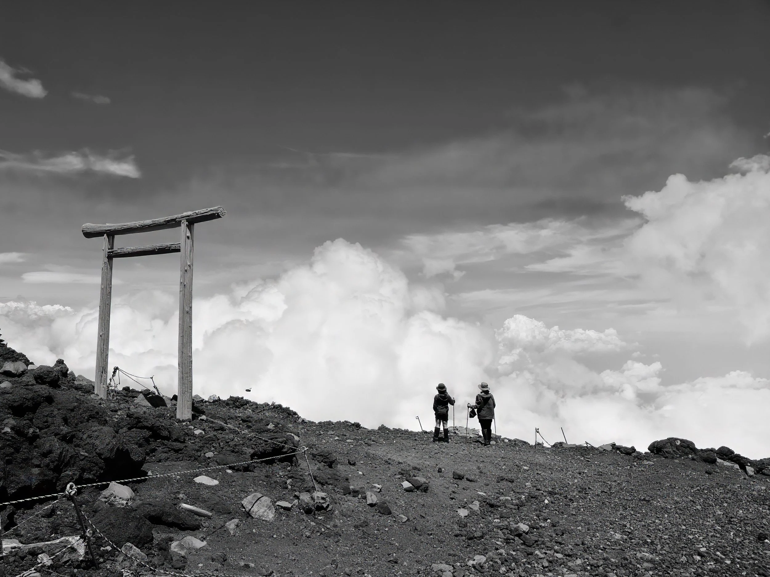 Mount-fuji-summit-torii-gate-hikers-japan-landscape-bw.jpg