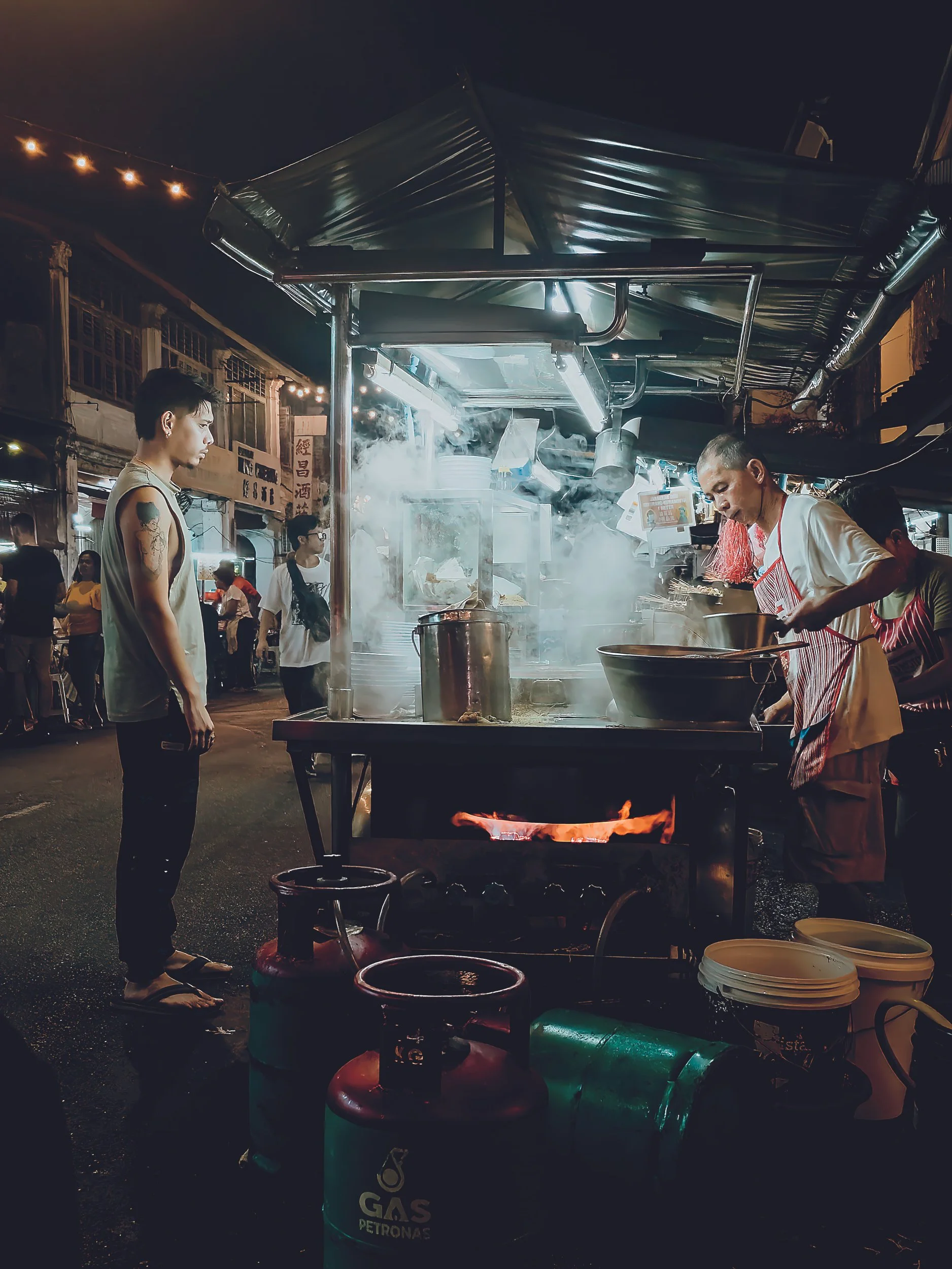 penang-street-food-market-malaysia-vendor-cooking-fire-noir.jpg