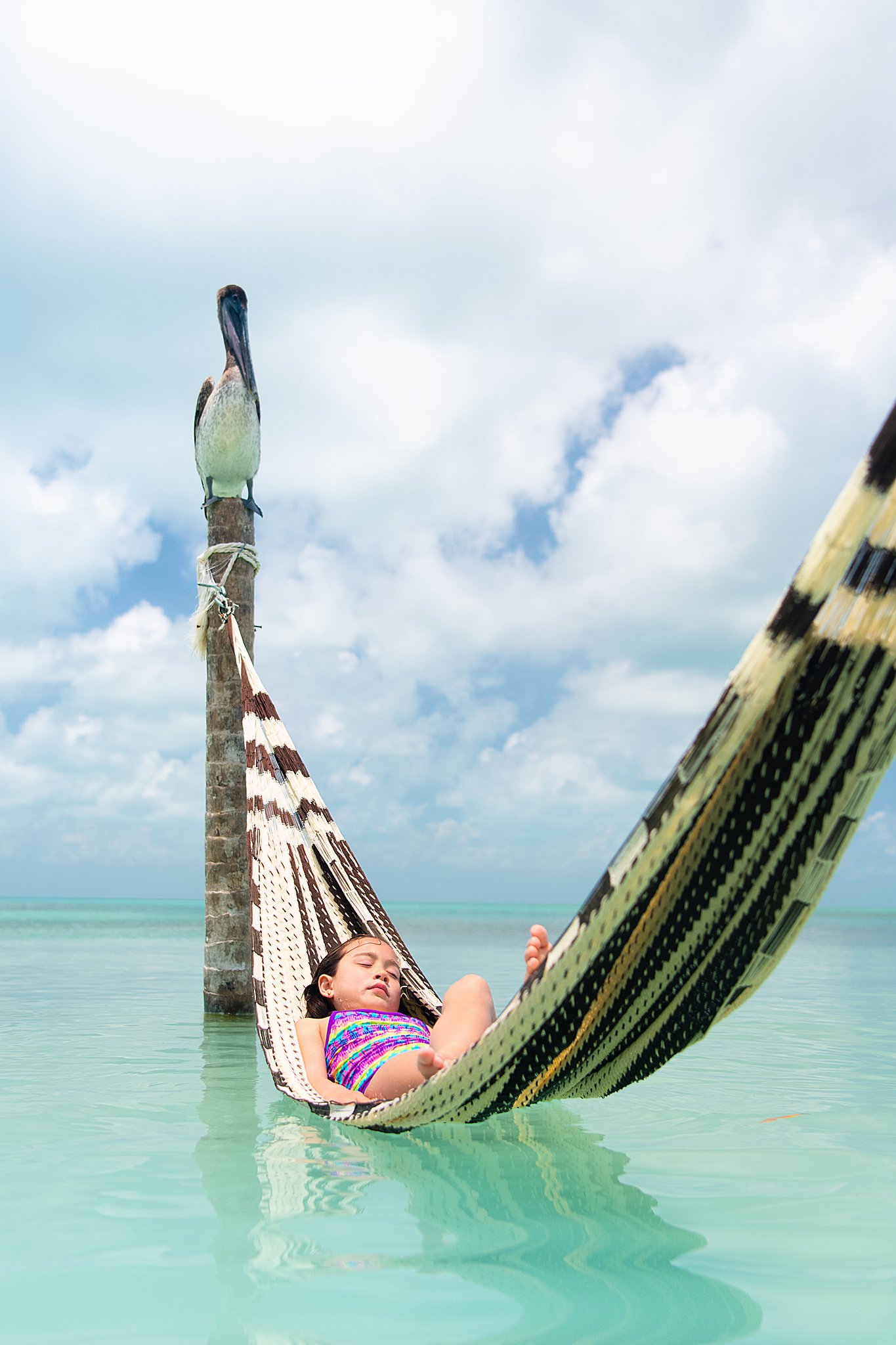 child-resting-hammock-turquoise-water-beach-serenity.jpg