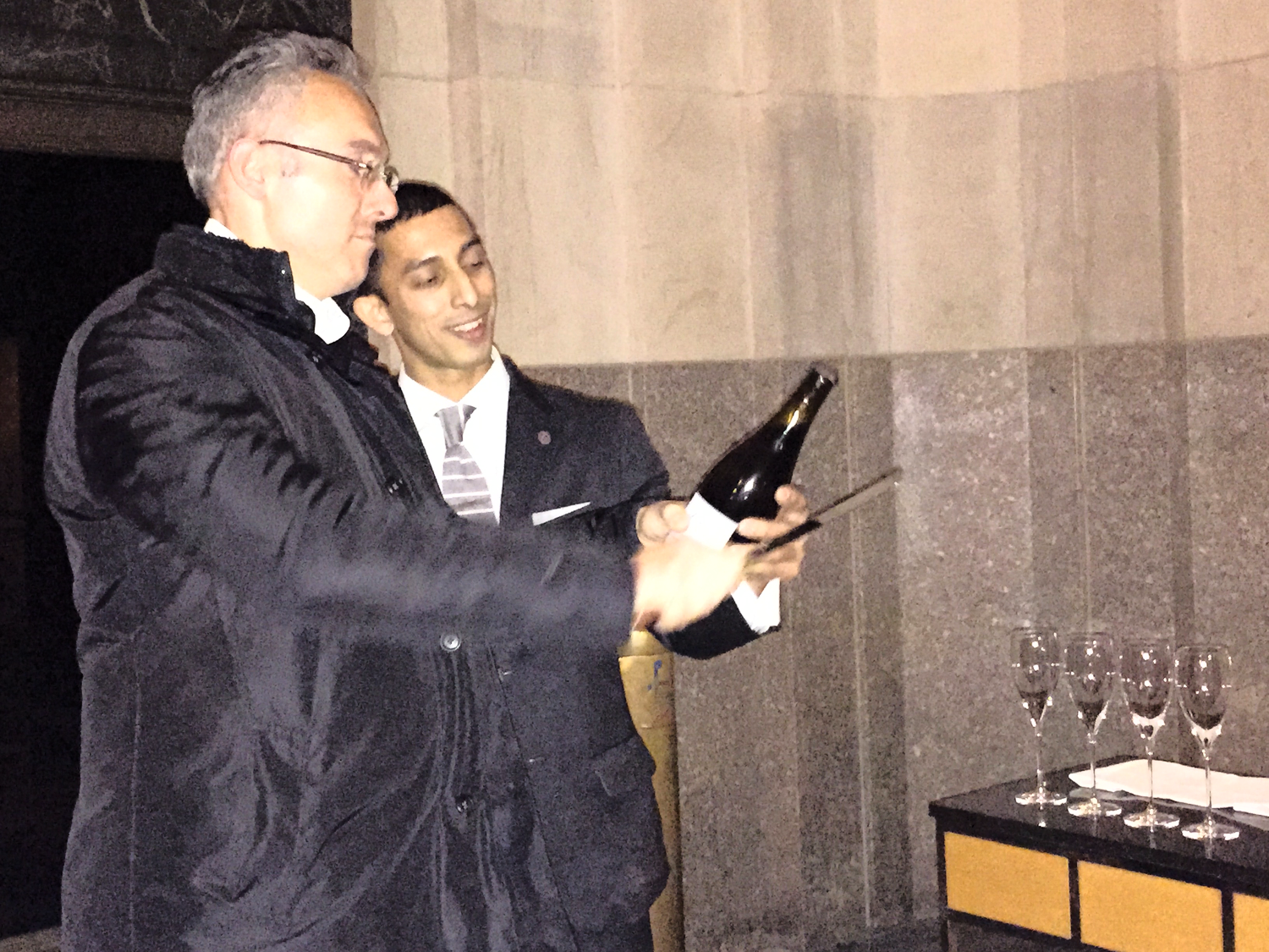 Florencio demonstrating the Art of Sabrage on a well chilled bottle