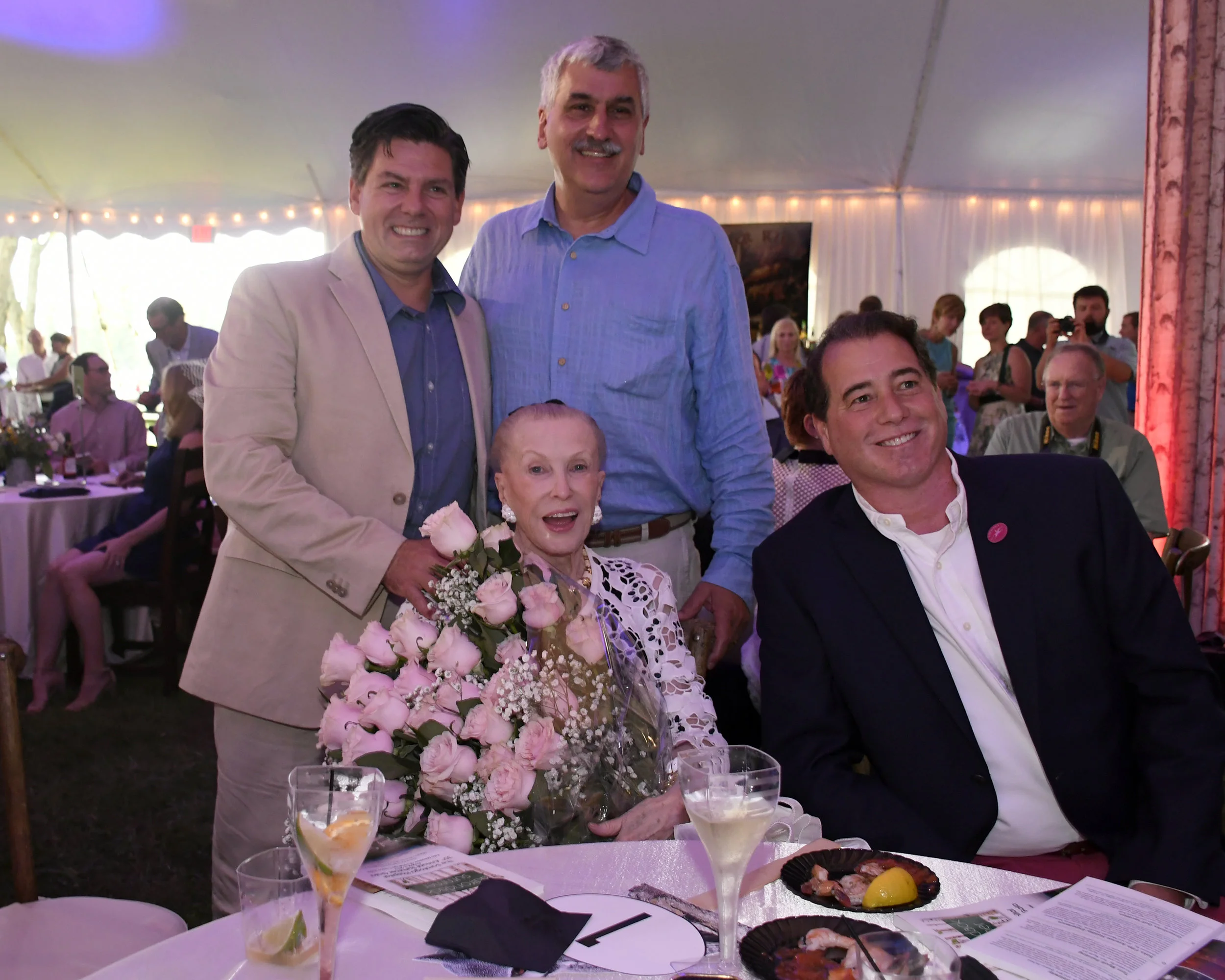 Marylou Whitney being presented with 35 pink roses in recognition of Marylou and John Hendrickson's tremendous support of Saratoga Hospital