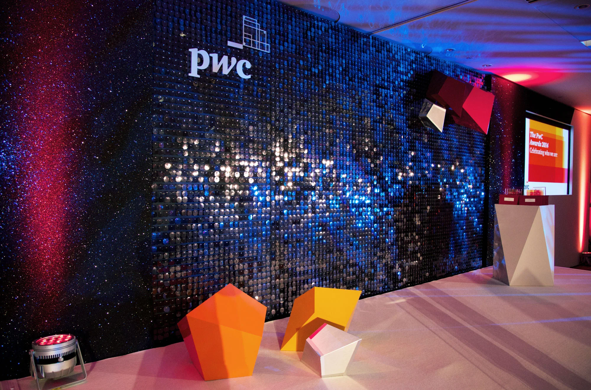 2014 Stage set with geometric shapes, furniture and shimmer wall