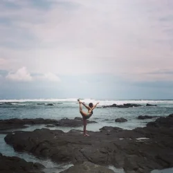 The ultimate in self-care: During a month-long work exchange program at The Yoga Farm Costa Rica, Bonnie settles into Dancers Pose in the tide pools of the Pacific Ocean.