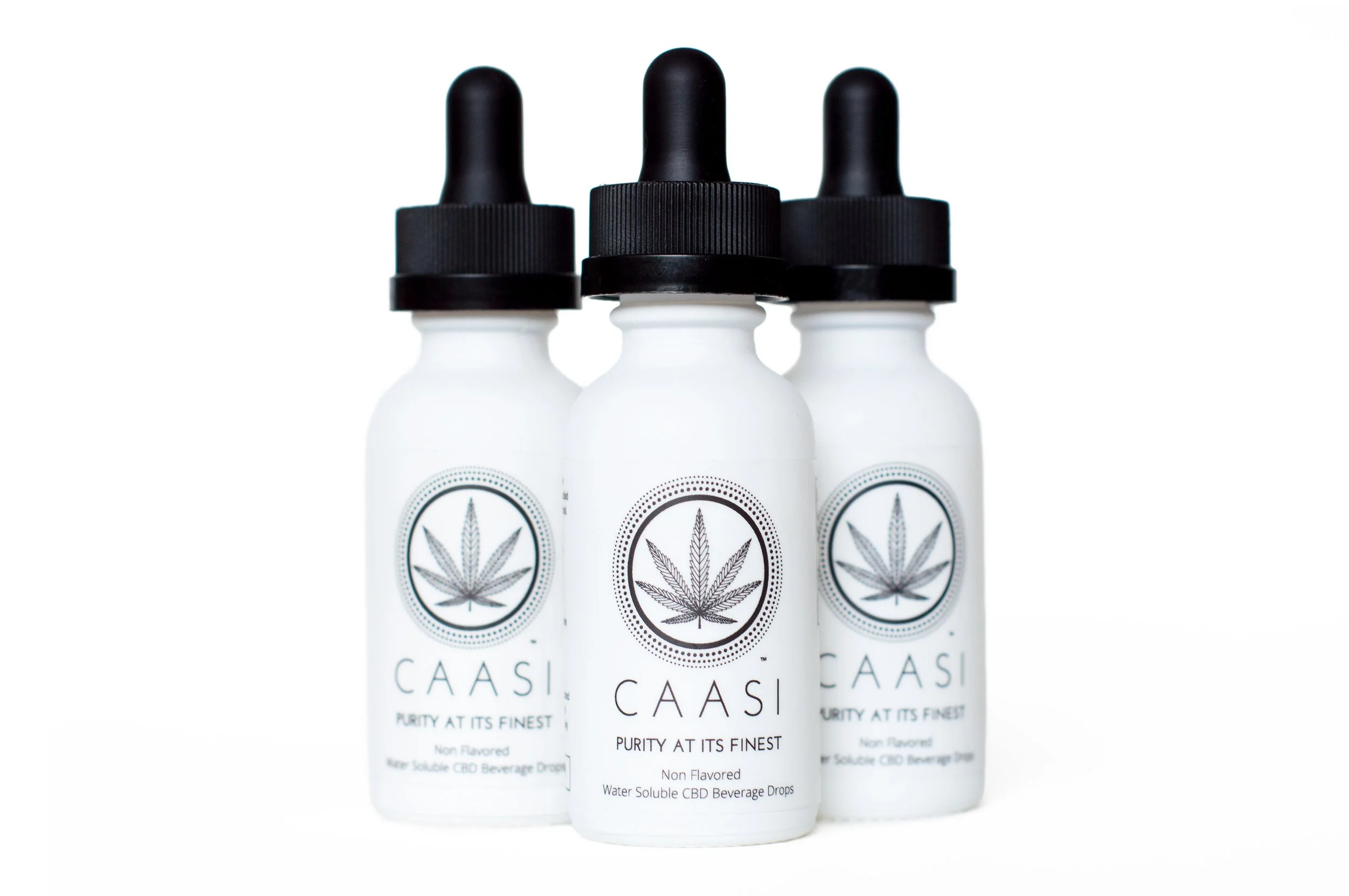 Three white bottles with black caps and droppers labeled "CAASI" with a cannabis leaf logo, and text indicating they are CBD beverage drops, non-flavored and water-soluble.
