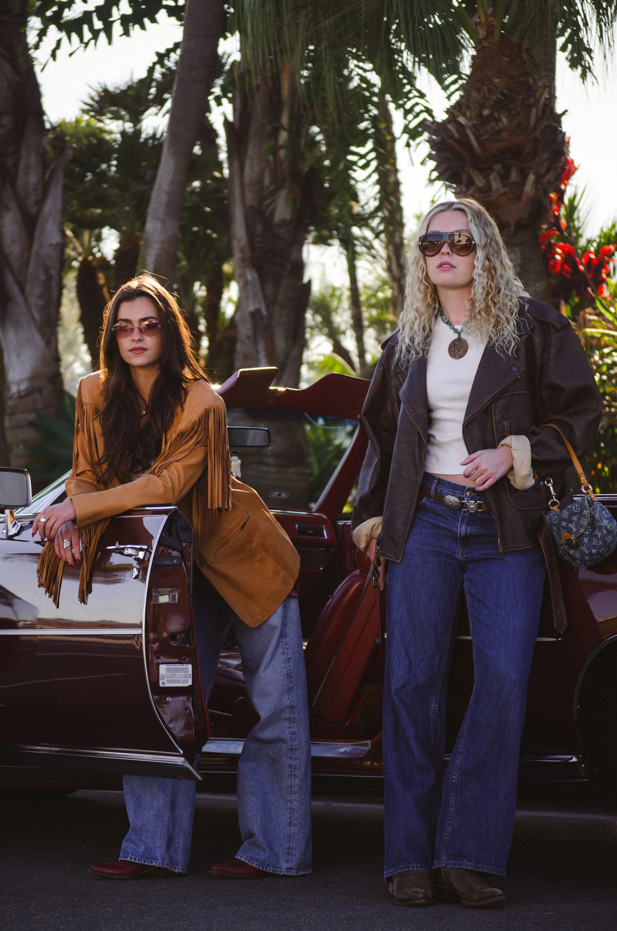 Fashion Editorial Shoot in Newport Beach, California for Lovergirl Vintage. Two girls leaning against red convertible.