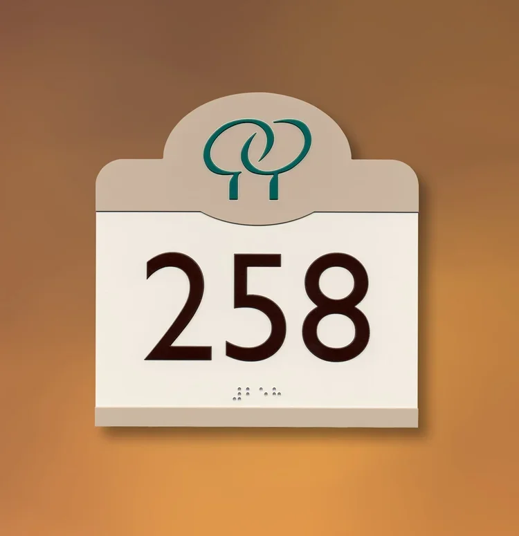 Standard ADA room number 258 sign with raised characters and Braille, installed in a commercial building in Houston.