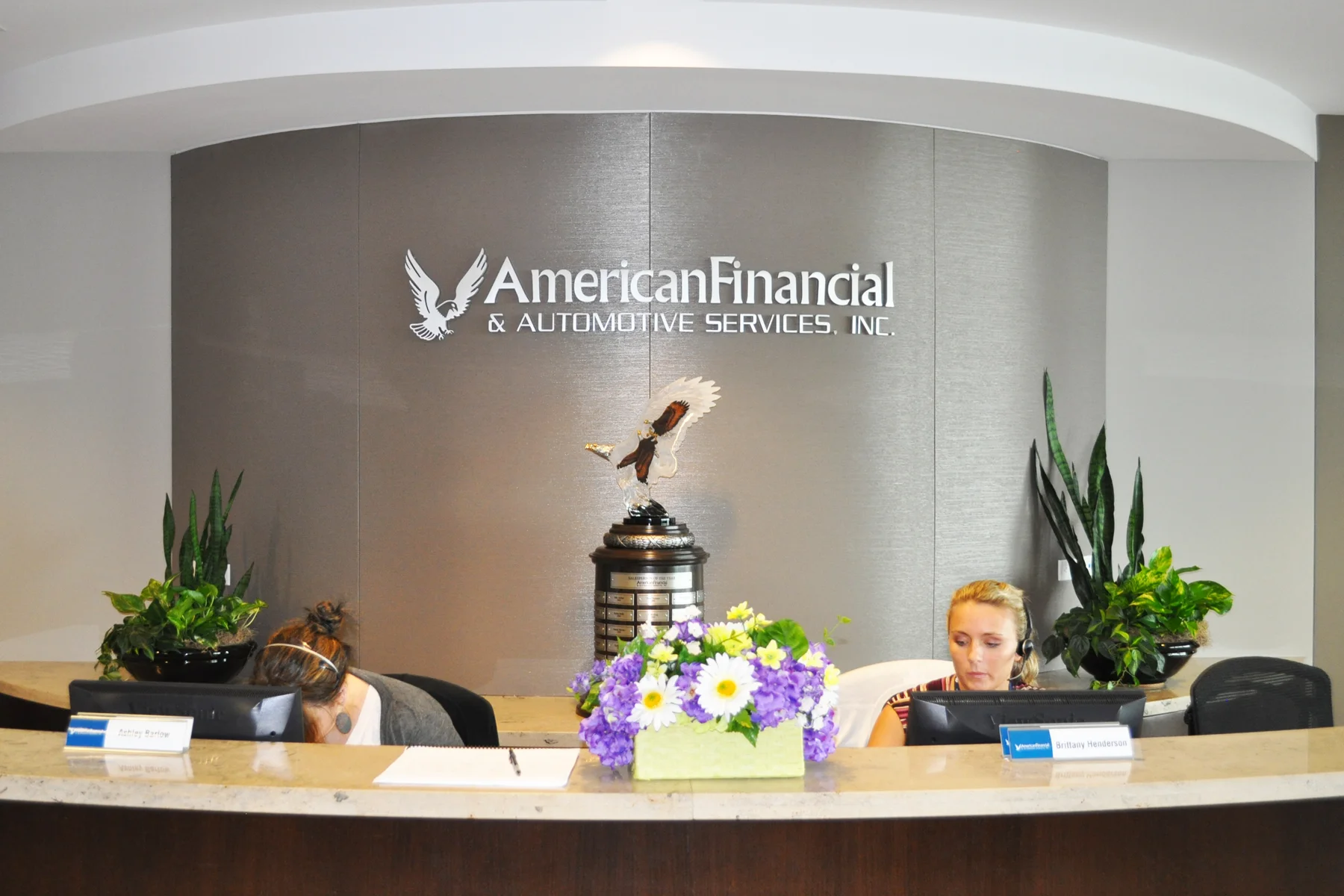 Curved Reception Wall Sign - Brushed Aluminum Letters stud mounted for floating effect on a round interior fabric wall